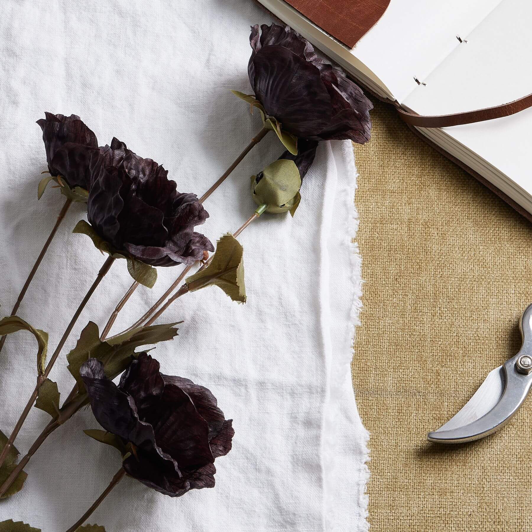 Black artificial poppy stem with dramatic ebony petals, 83cm tall, perfect for modern home decor  by Sostter at brixbailey.com