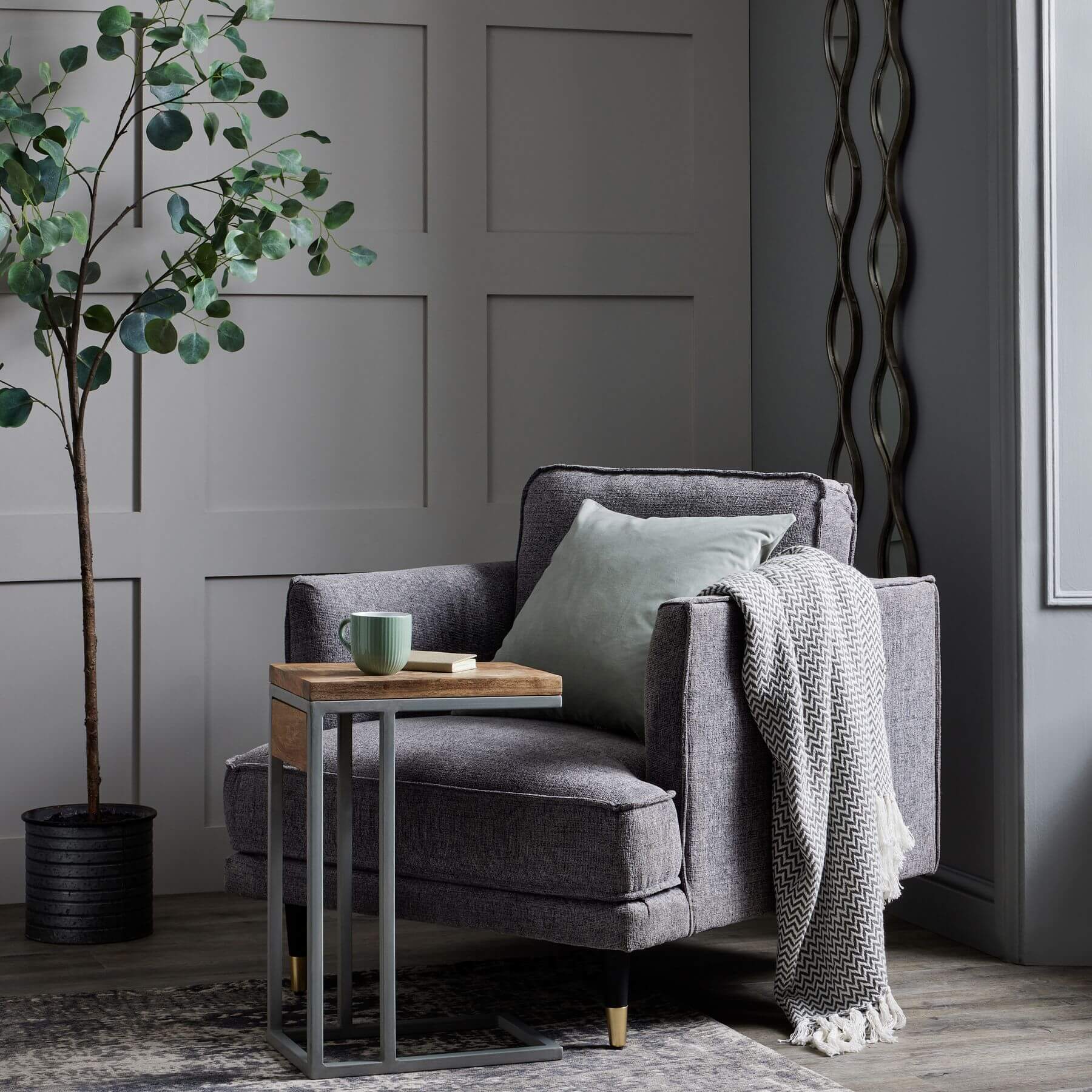 Grey fabric armchair with plush cushioning, curved arms, and neutral design for modern or traditional interiors. by sostter at brixbailey.com