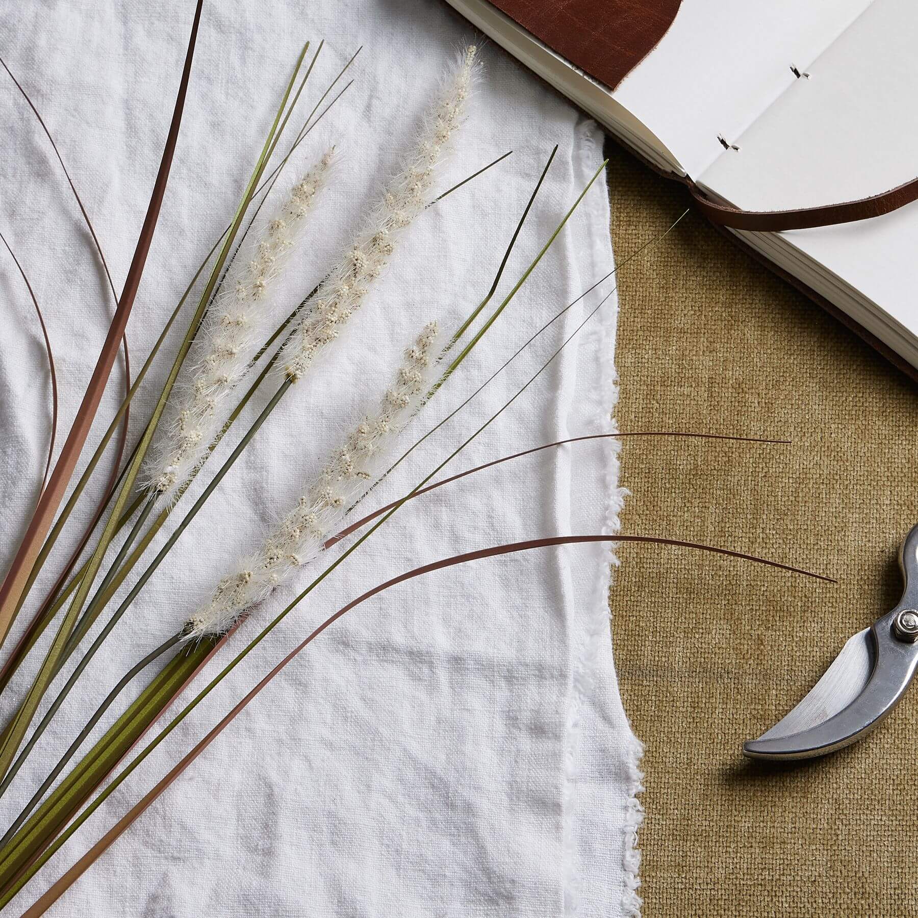 Lifelike artificial grass stems in soft cream, 80cm tall, with triple-stem design for natural home decor by RoomLondon at brixbailey.com