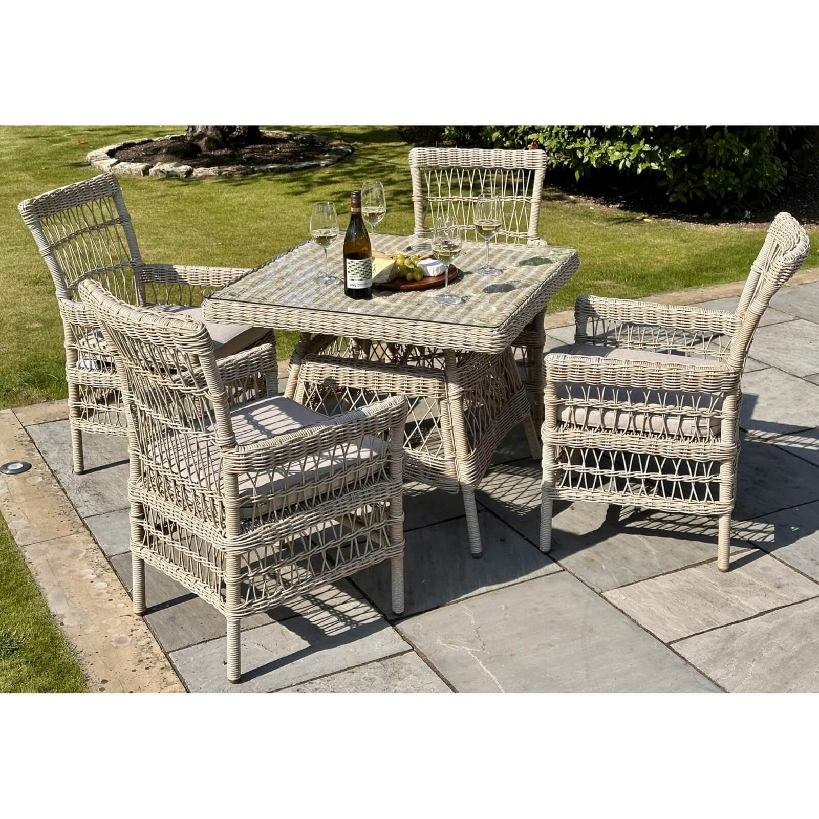 Provence 4-seater outdoor dining set in beige HDPE rattan with tempered glass table and Olefin cushions by Sostter at brixbailey.com