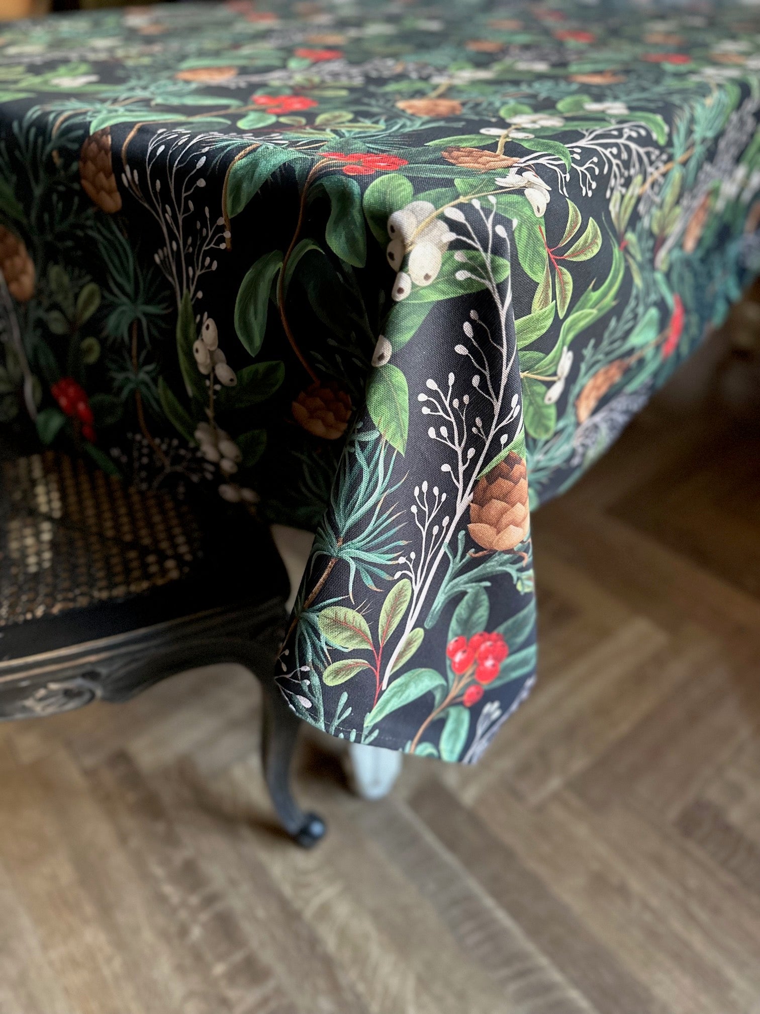 soft cotton christmas forest tablecloth draped on a table in warm morning light