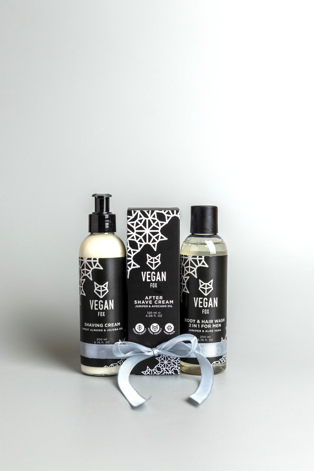 bold men's body and face set with forest scent, featuring 2-in-1 shower gel, shaving cream, and aftershave on dark slate