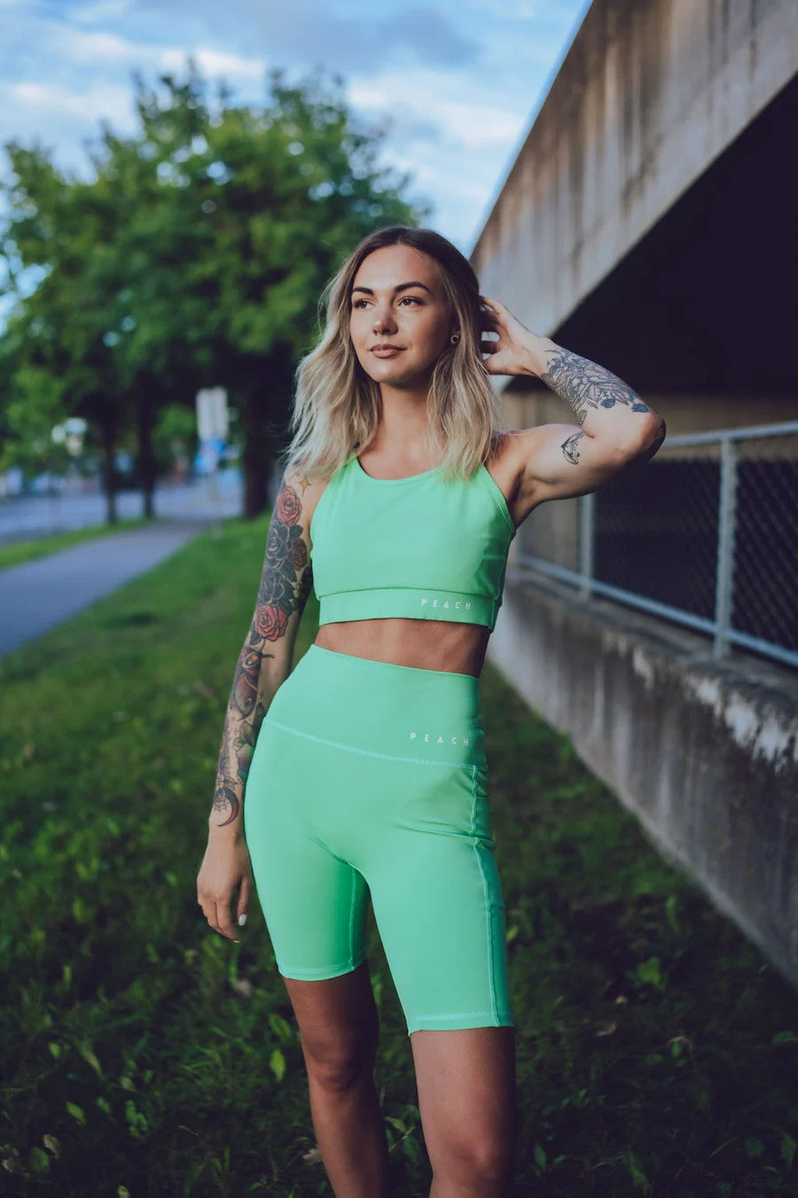elegant high-waisted green biker shorts with side pockets on a minimalist background