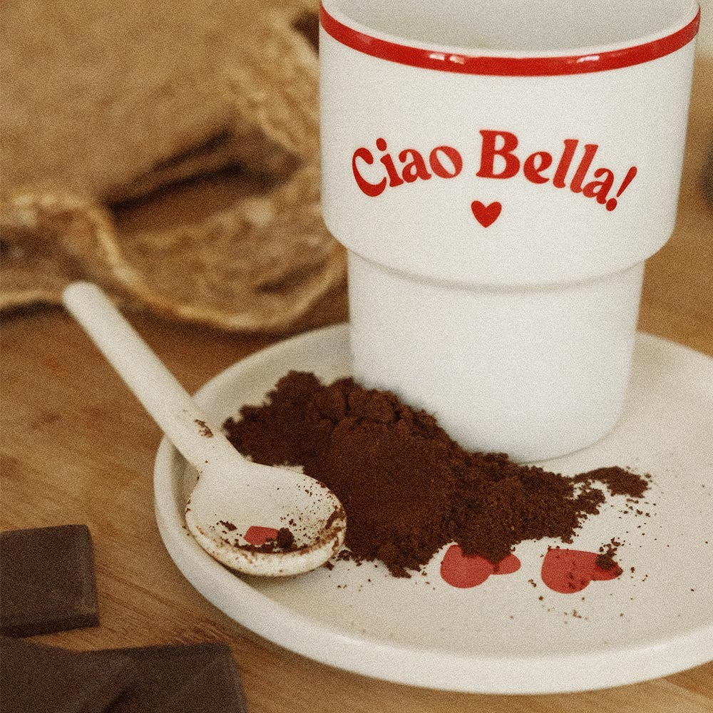 ciao bella ceramic mug on a rustic table with morning light highlighting its elegant italian typography