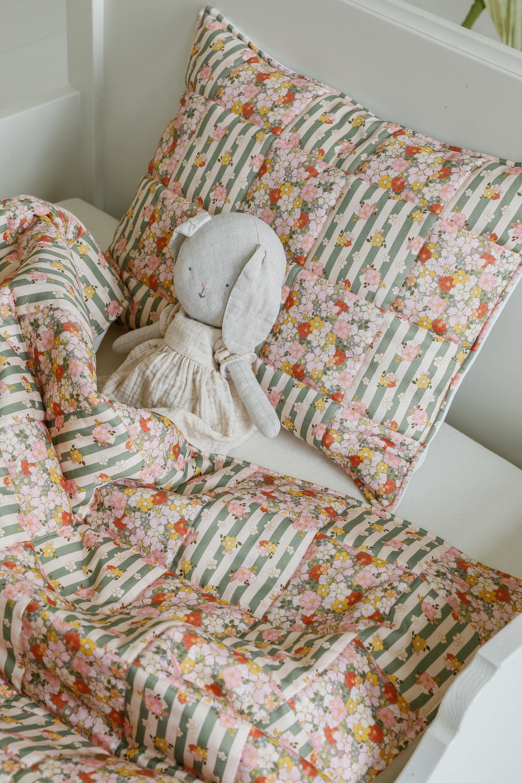 bold green garden cotton quilted blanket and pillow set, patchwork design on a neutral background