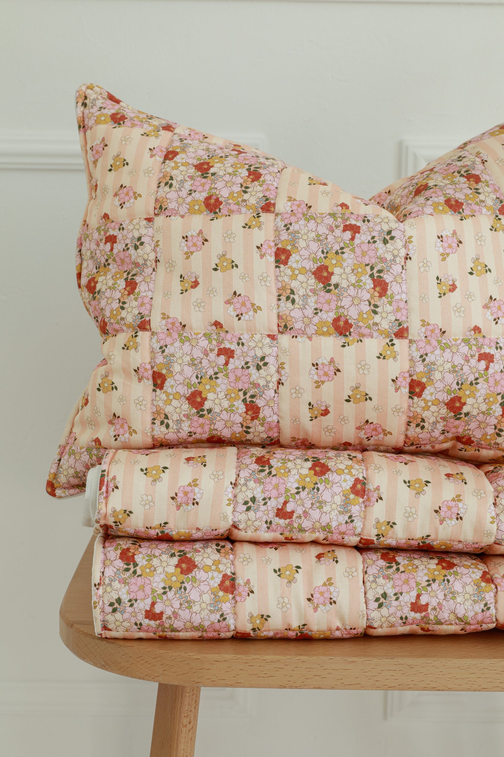 bold close-up of a handcrafted cotton patchwork quilt with vibrant spring garden patterns