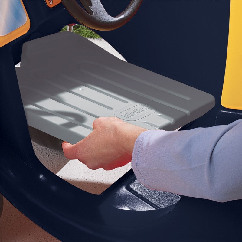 a child playing with the cozy truck ride-on toy in a sunlit backyard adventure