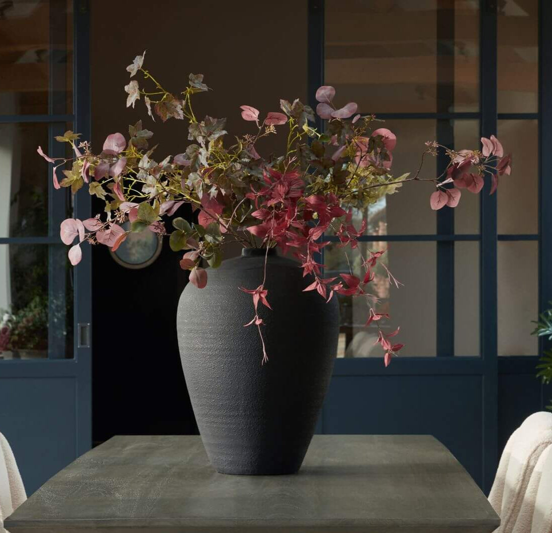 Minimalist matt black ceramic floor vase, 57 cm tall, with slim neck for effortless styling and dramatic silhouette.by sostter at brixbailey.com
