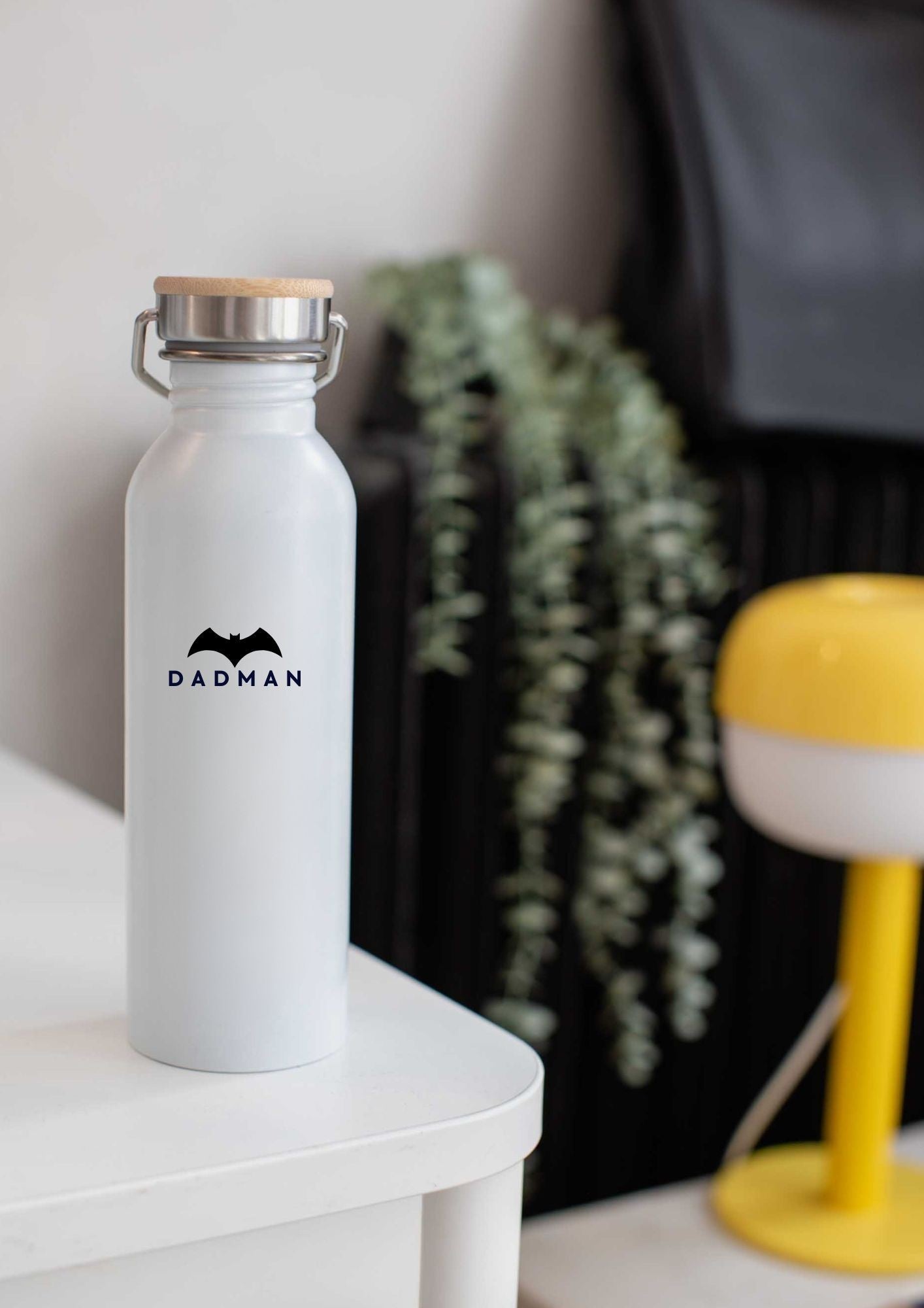 elegant black stainless steel thermos with a bamboo lid on a marble surface