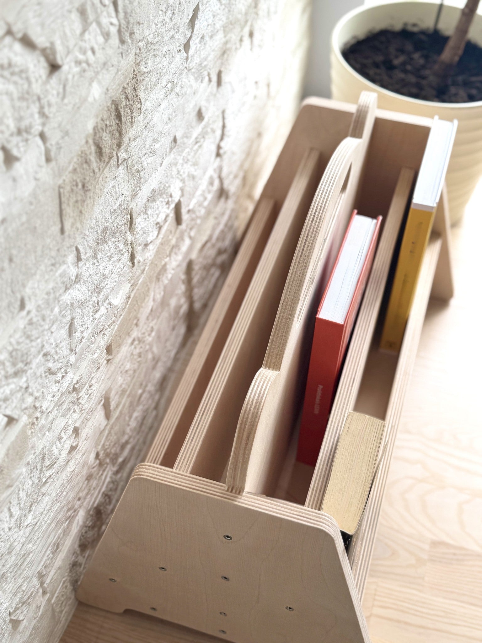 elegant birch bookshelf in a softly lit nursery with a curated selection of childrens books