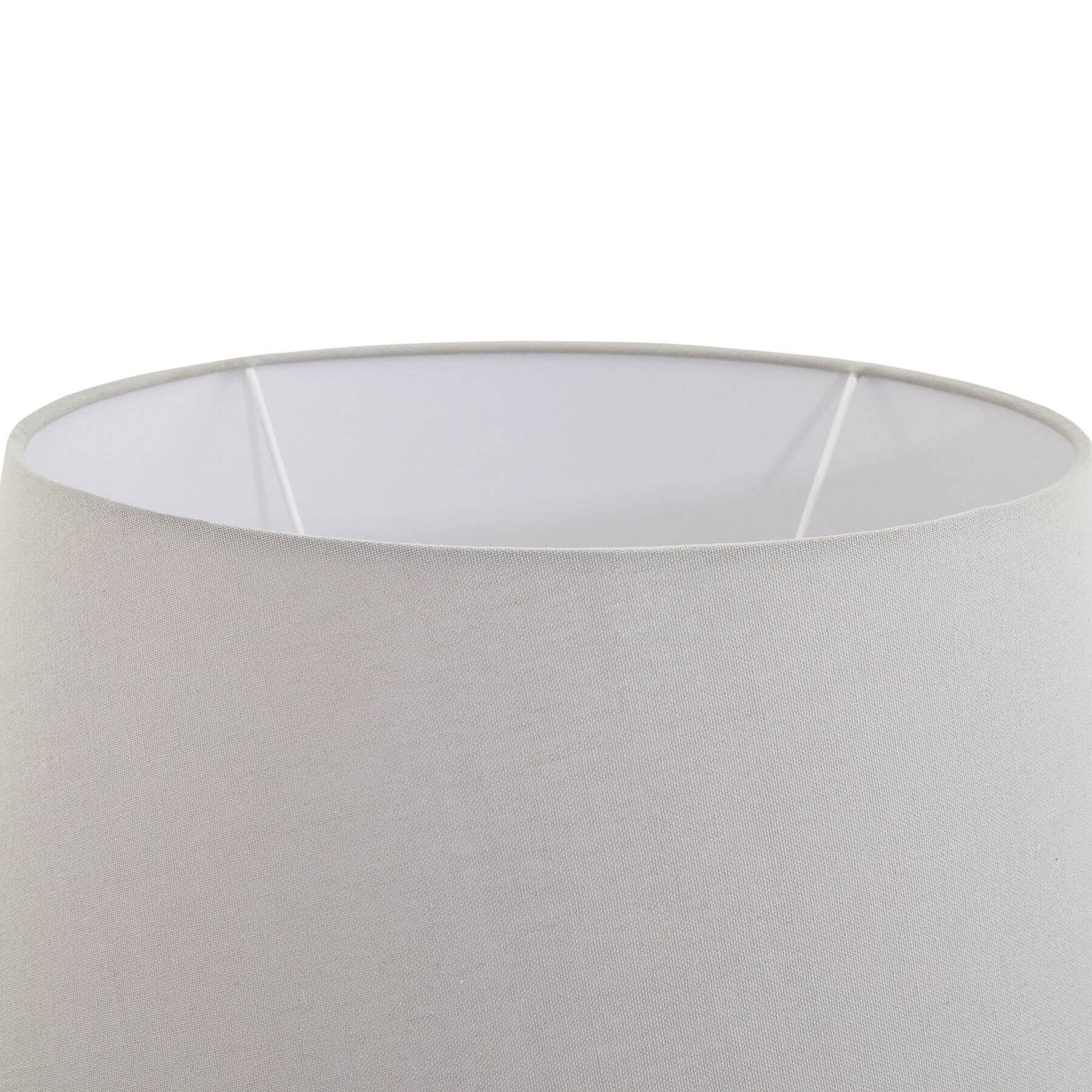 Stone-effect ceramic lamp with light grey fabric shade, hand-finished textured base, and warm ambient glow. by sostter at brixbailey.com