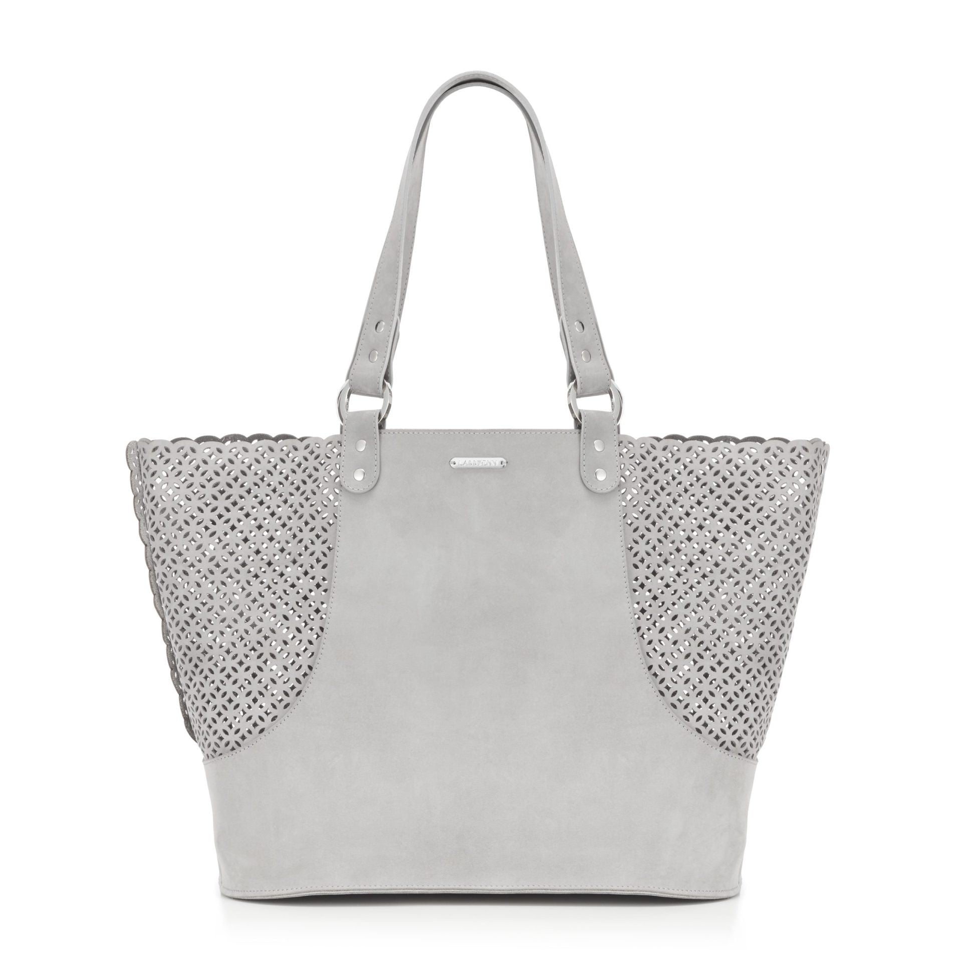 playful light grey dog carrier with a happy small dog peeking out from the chic nubuck leather bag