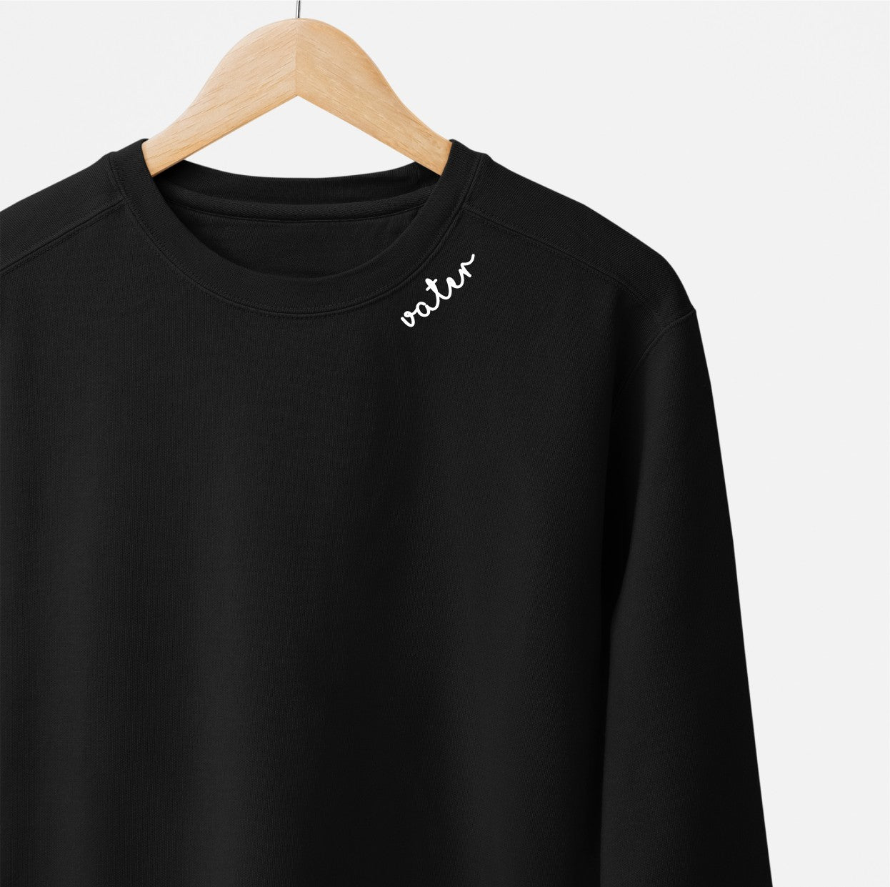 close-up of the embroidered vater collar on a navy organic cotton sweatshirt