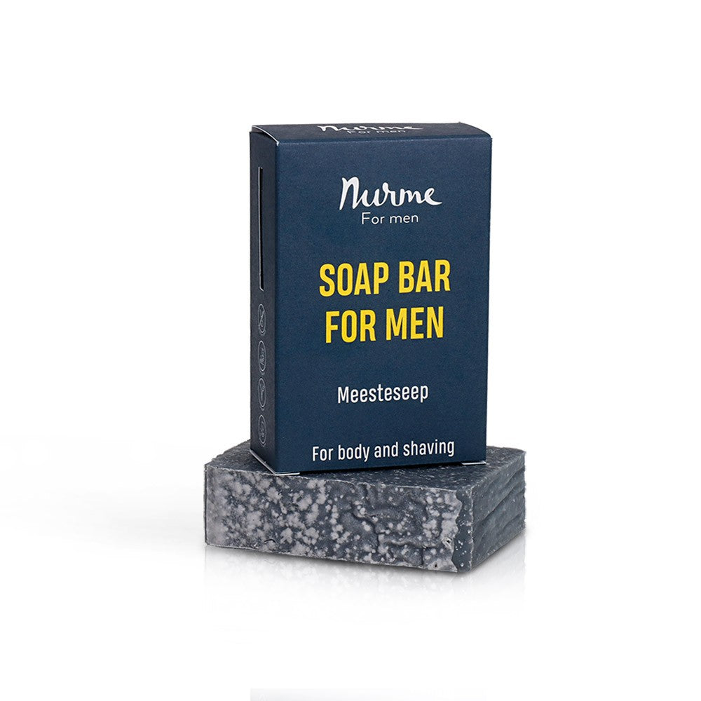 a close-up of a handmade men's soap bar with charcoal and sea salt on a soft, natural linen background