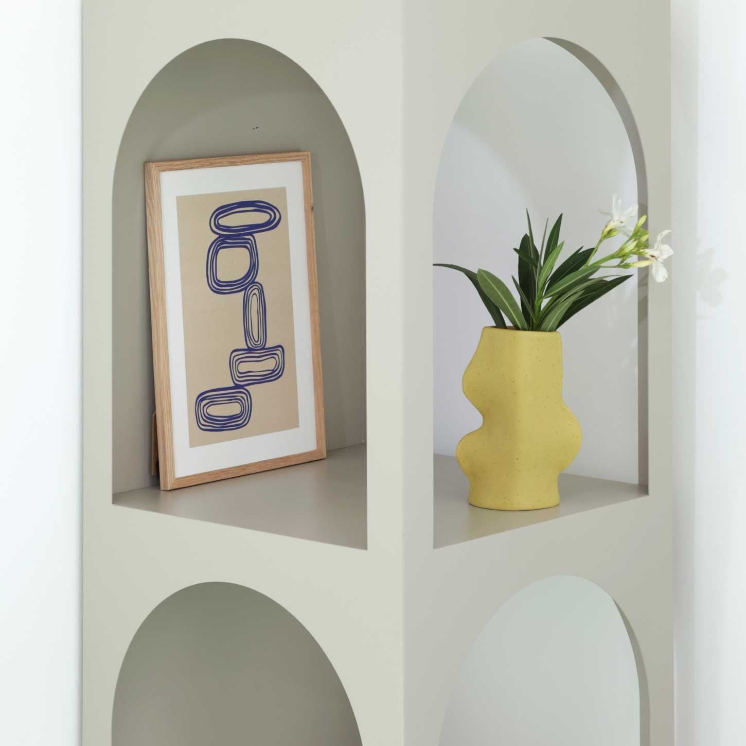 elegant pistachio ceramic vase on a minimalist shelf, showcasing its refined handmade curves and subtle matte glaze