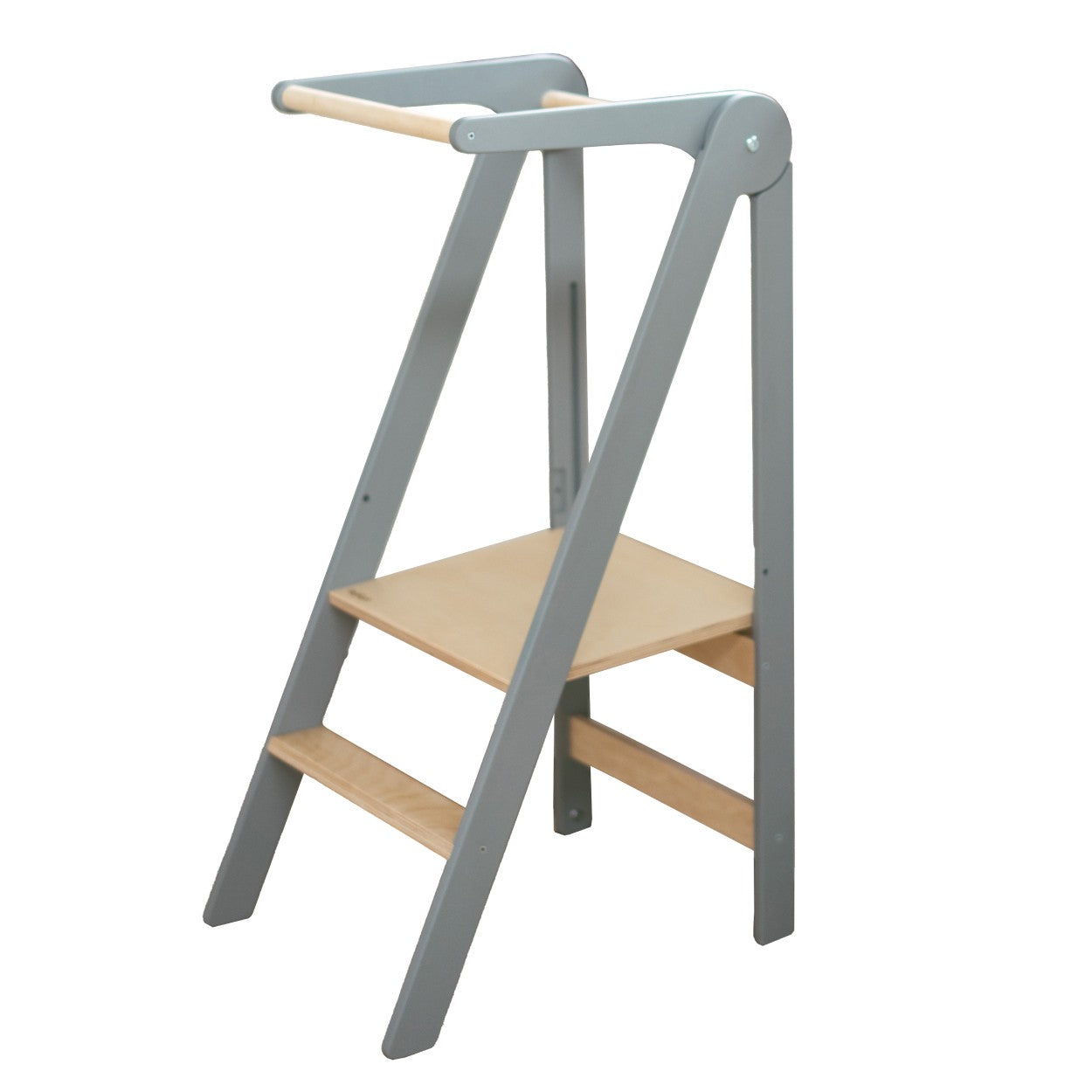 foldable kitchen helper tower in a bright, airy nursery with morning light highlighting its birch wood grain