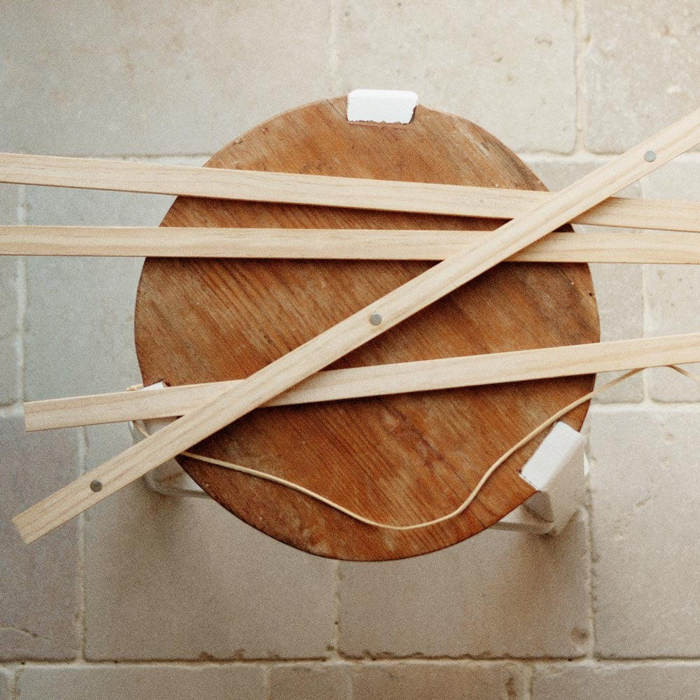 a playful close-up of the magnetic pine frame in a bright, sunlit room