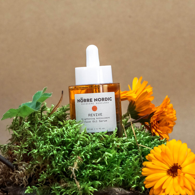 elegant glass dropper of nordic brightening face serum with golden amber oil