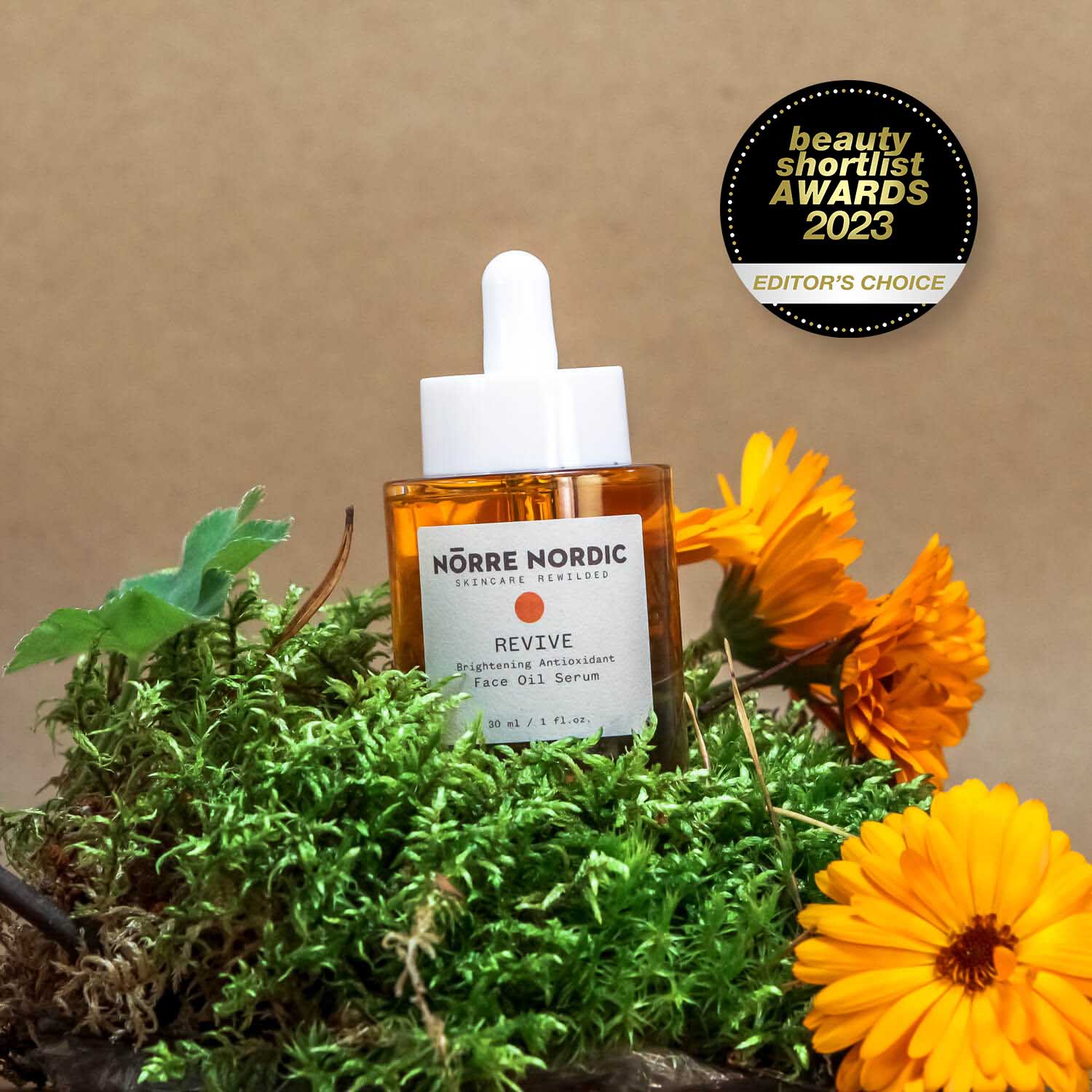 nörre nordic revitalizing face oil serum bottle with golden amber liquid and natural sediment