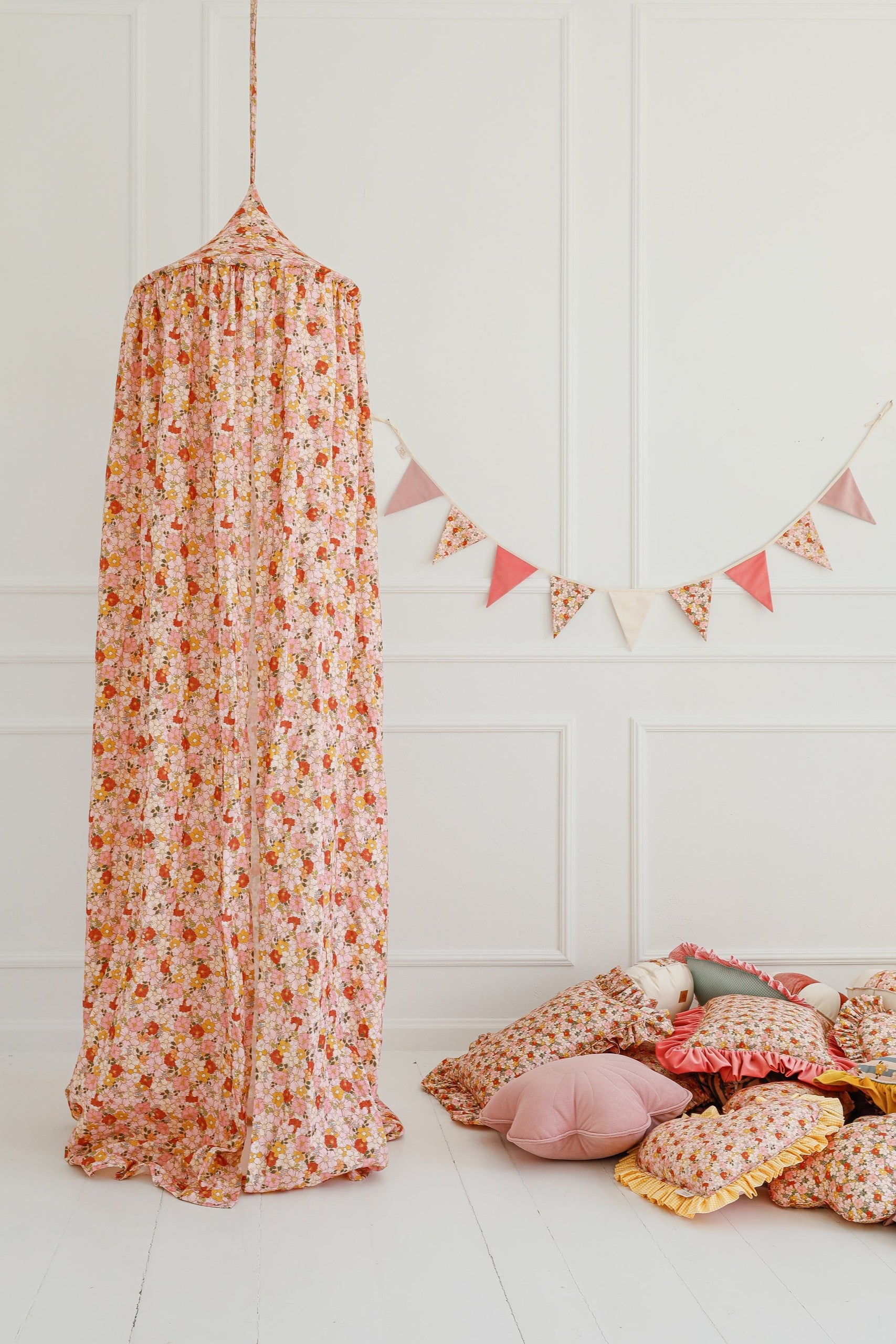 bold birthday garland in garden theme with cotton and velvet pendants hanging over a child's bed