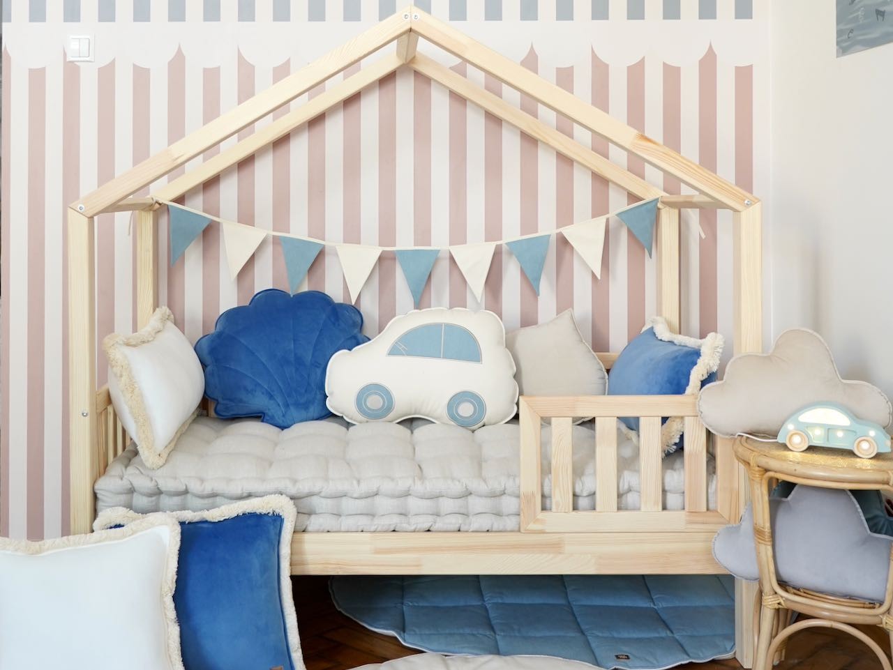 soft cotton and velvet jean garland draped over a wooden crib, creating a cozy nursery accent
