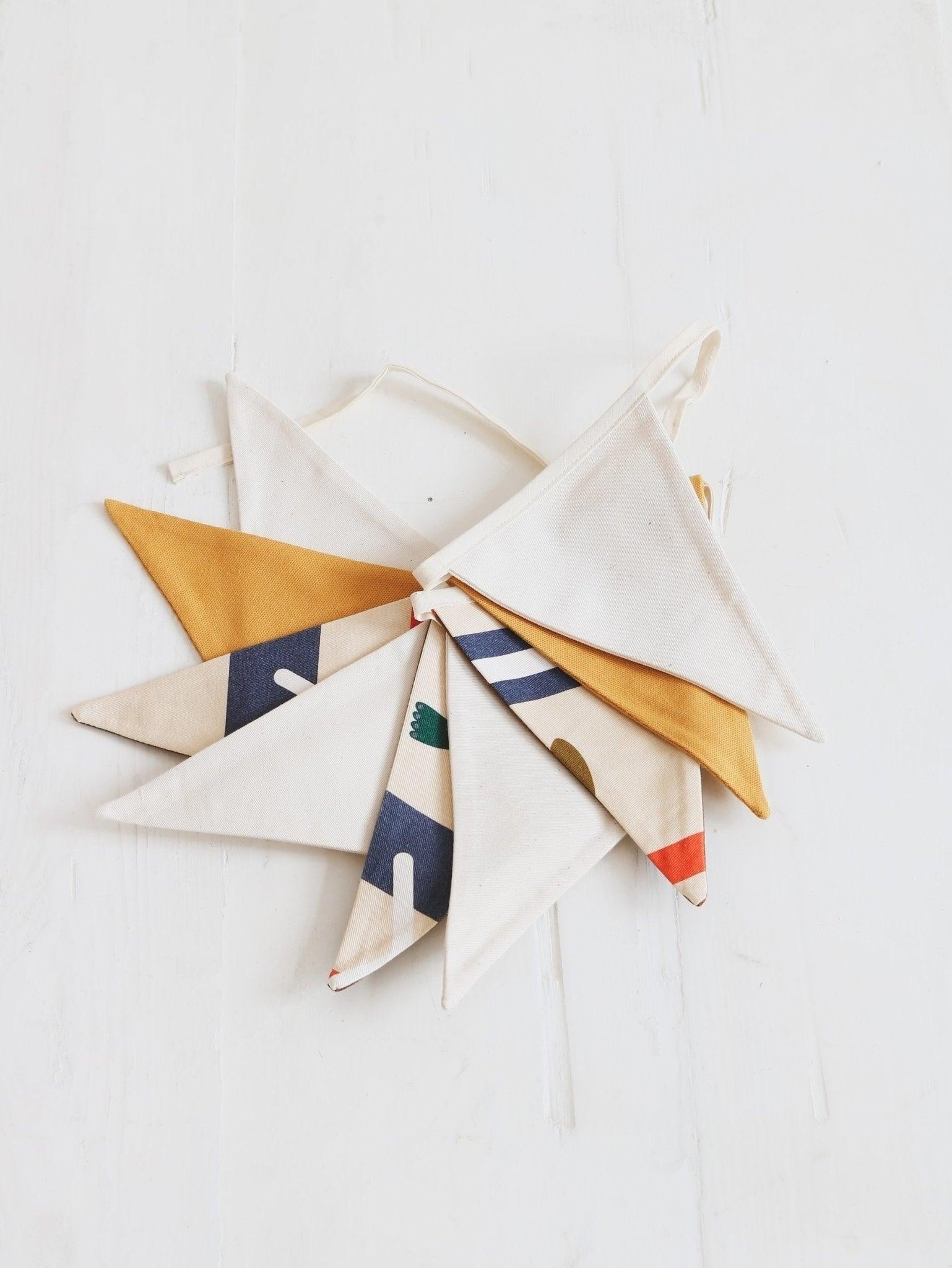close-up detail of handcrafted cotton native vibe garland with warm geometric shapes