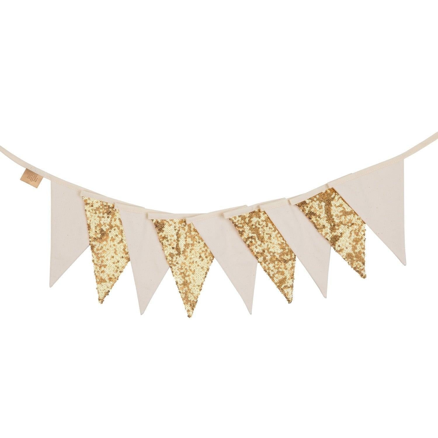 gold and beige sequin garland draped playfully over a crib, sparkling in warm sunlight