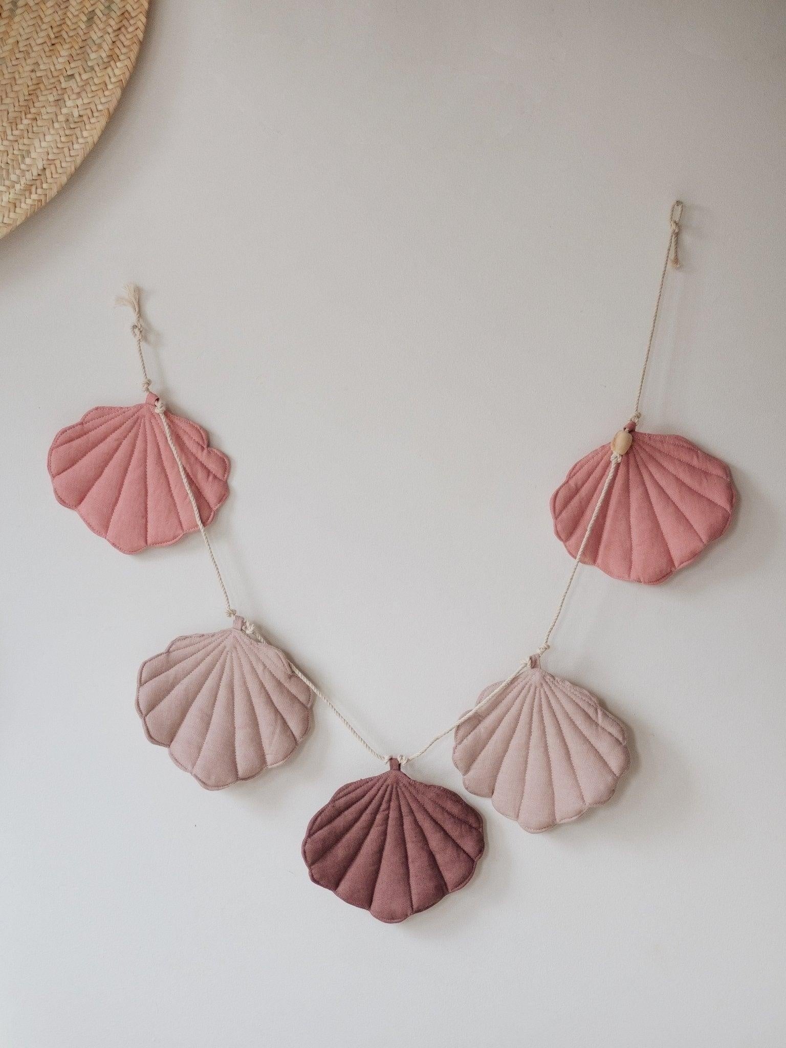 practical 3-meter powder pink shell garland draped over a wooden bead for versatile kids room decor