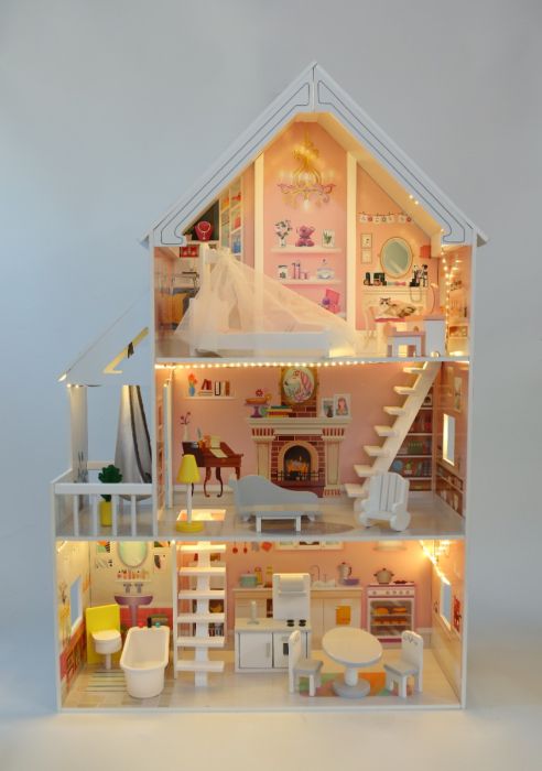 playful close-up of the liselle dollhouse's glowing led-lit terrace at dusk