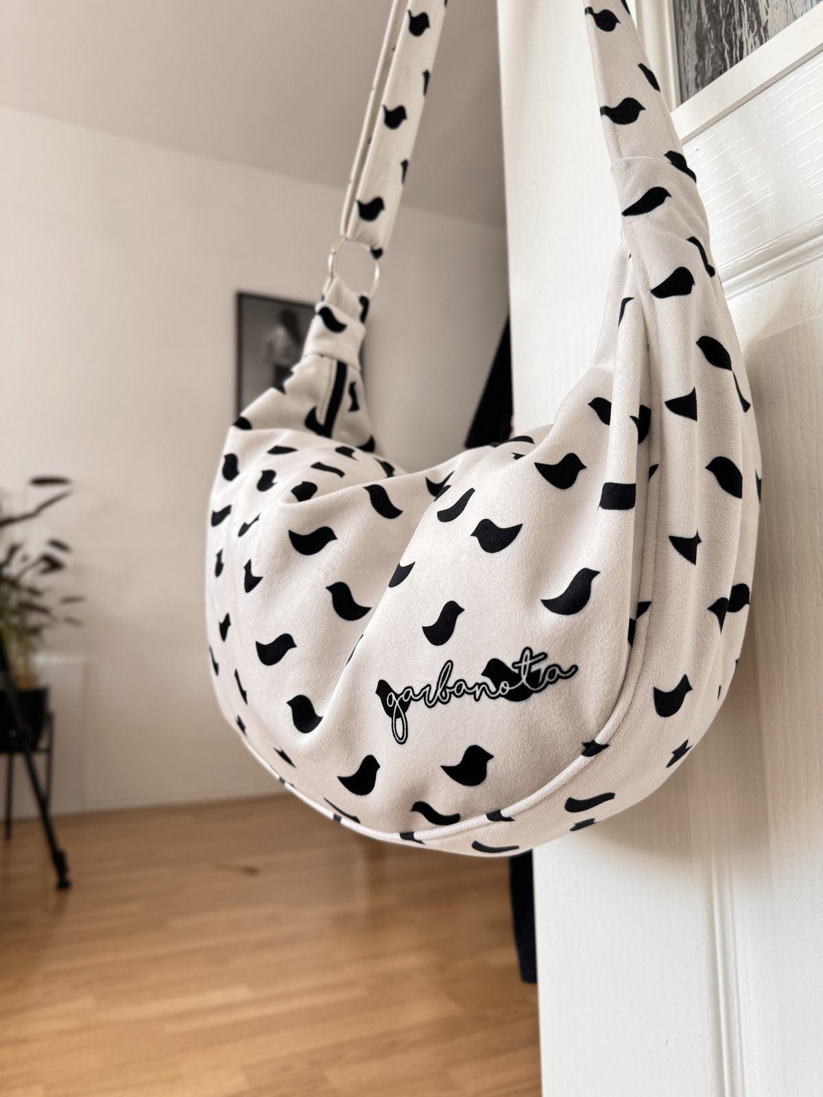 functional hobo bag with birds design showing interior pockets and adjustable velour strap