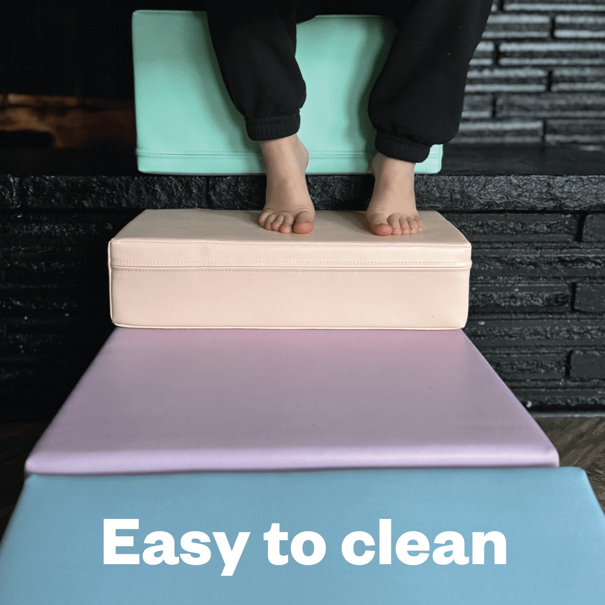 a toddler climbing on a soft pastel foam corner climber in a sunlit playroom