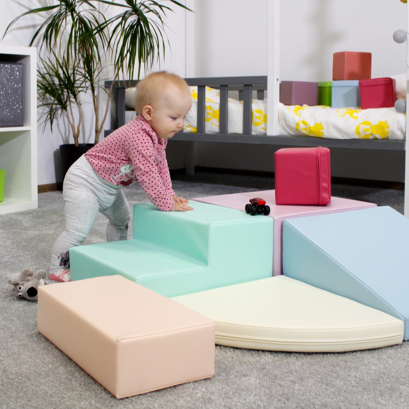 a soft pastel foam corner climber inviting gentle play and cozy moments for toddlers
