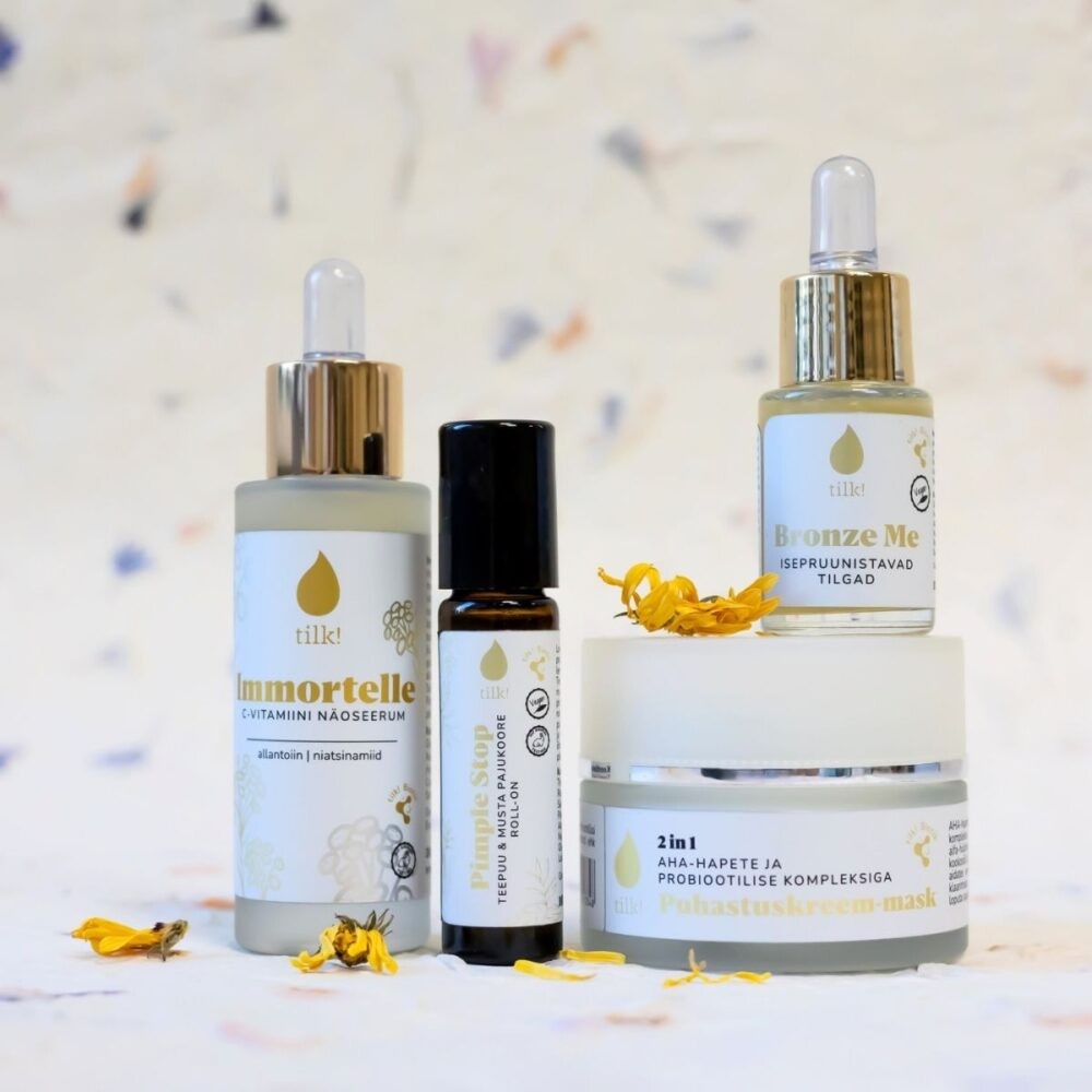 a playful splash of golden immortelle serum with vitamin c, glowing on skin