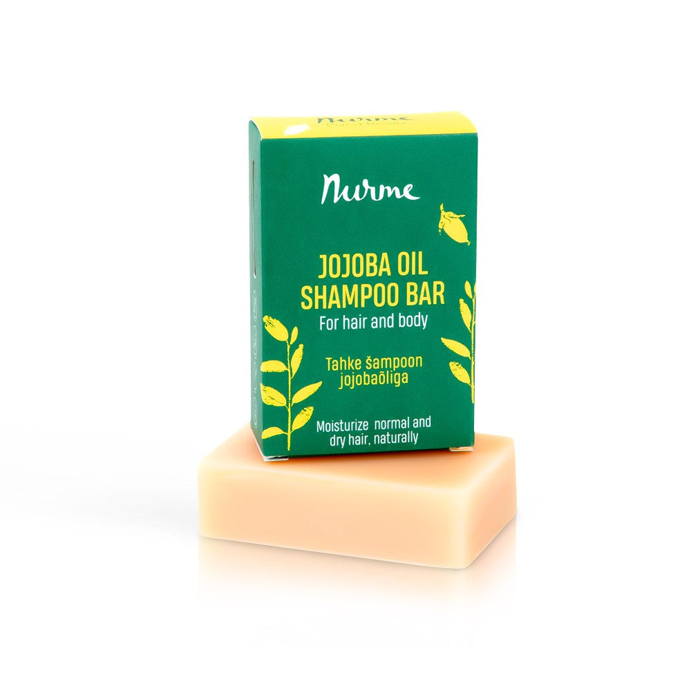 bold close-up of a nourishing jojoba oil shampoo bar with rich lather on wet hair
