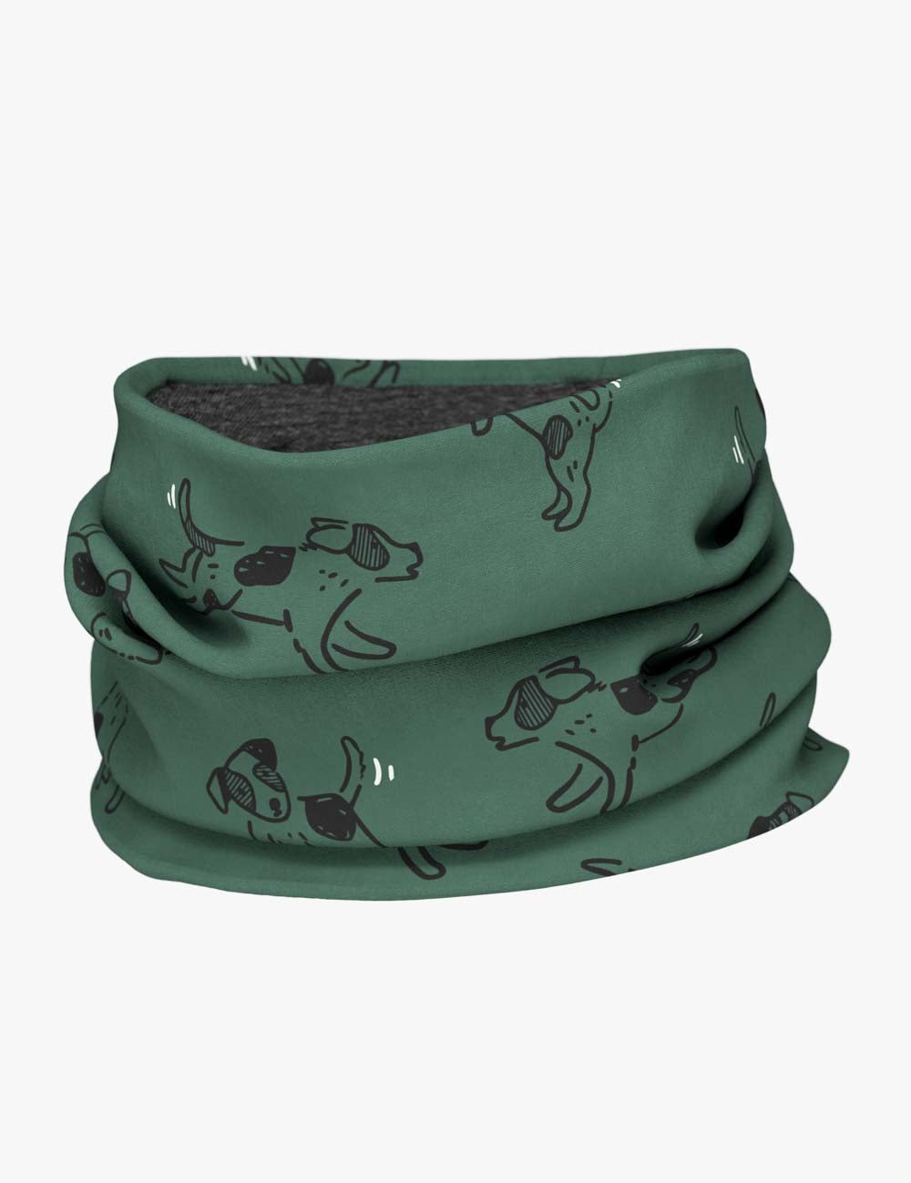 a soft green kids neck tube with a playful dog print, shown in gentle morning light