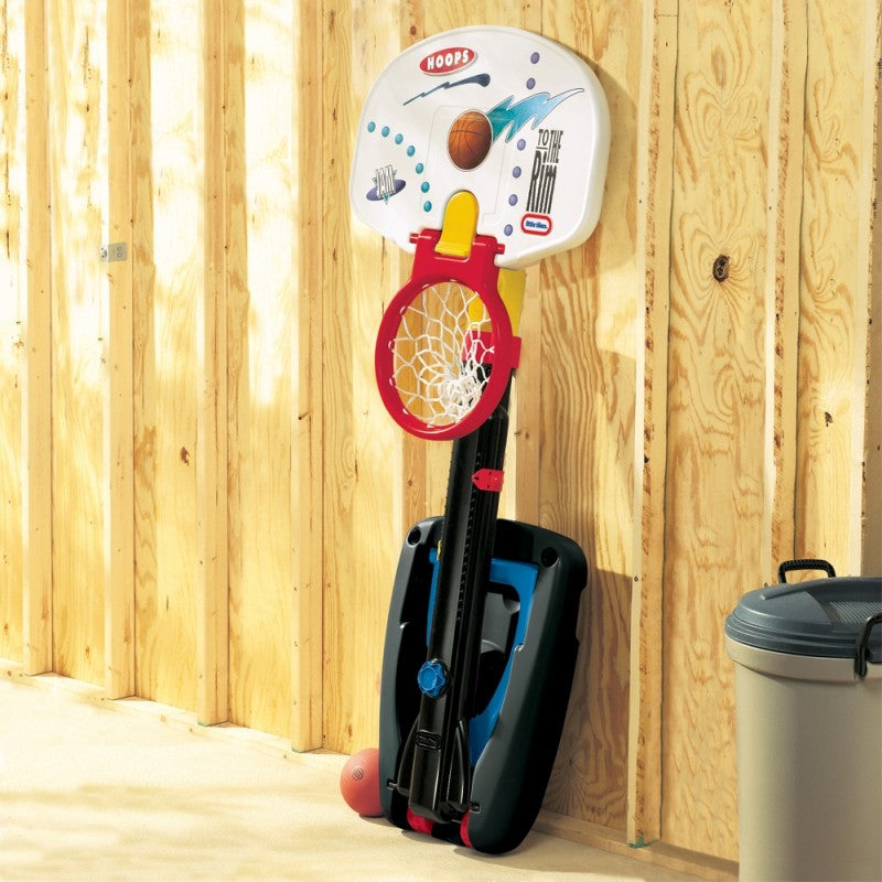 a child gently lowering the adjustable basketball hoop for easy storage in a cozy playroom