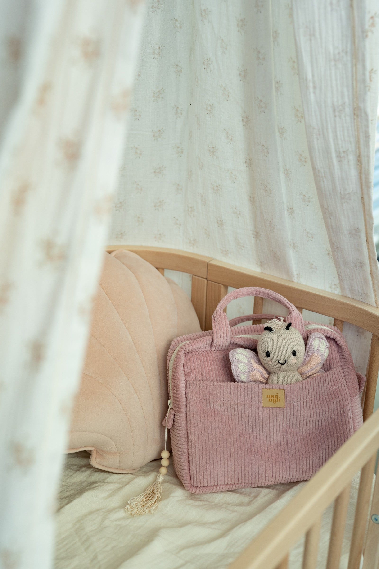 elegant handmade baby pink makeup bag open on a marble surface, revealing its spacious interior and pockets