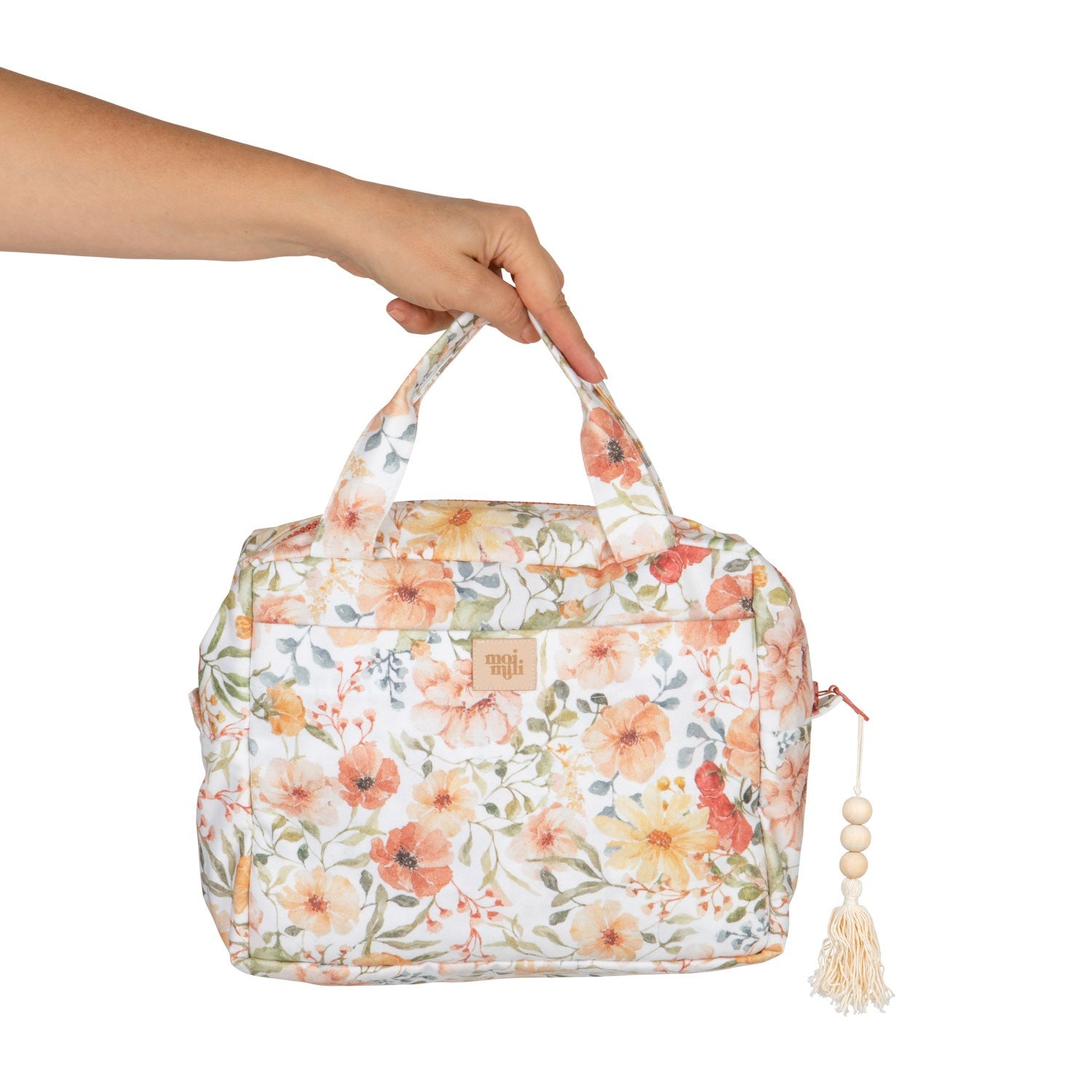 bold floral makeup bag set of 2 - large and small cotton pouches with vibrant flower power print, open on a wooden table