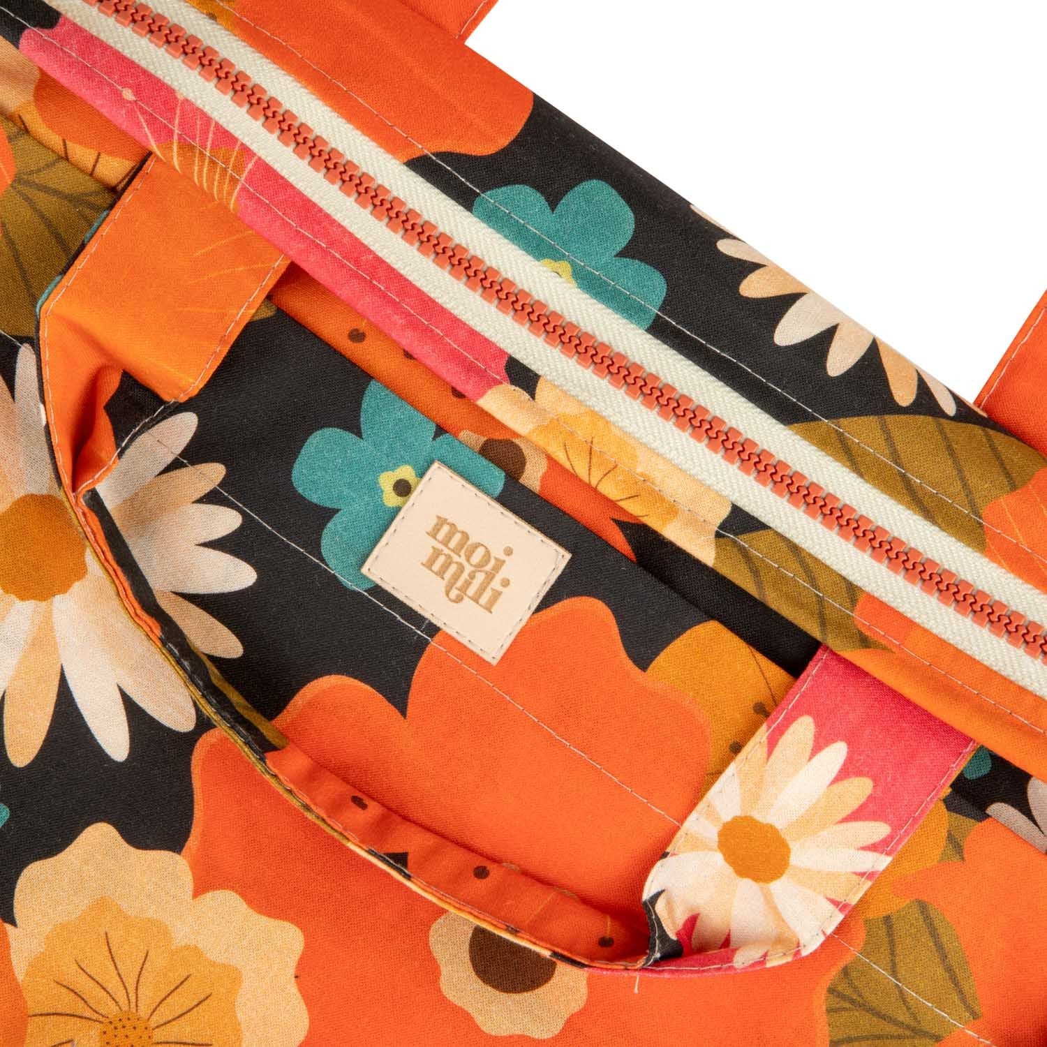 playful floral makeup bag held open, showing its spacious waterproof interior and pockets