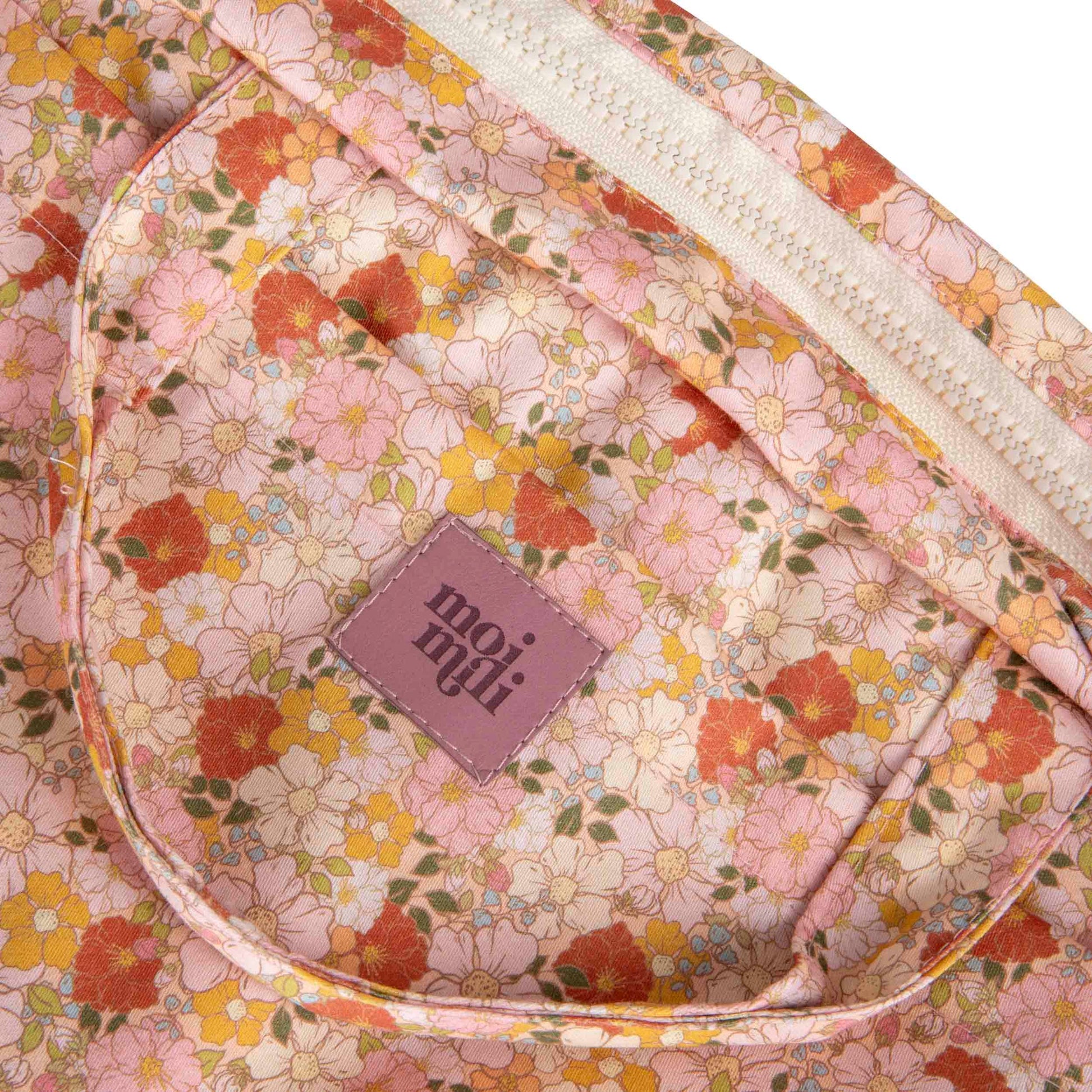 soft pastel spring garden makeup bag with floral details, open to show spacious cotton interior and waterproof lining