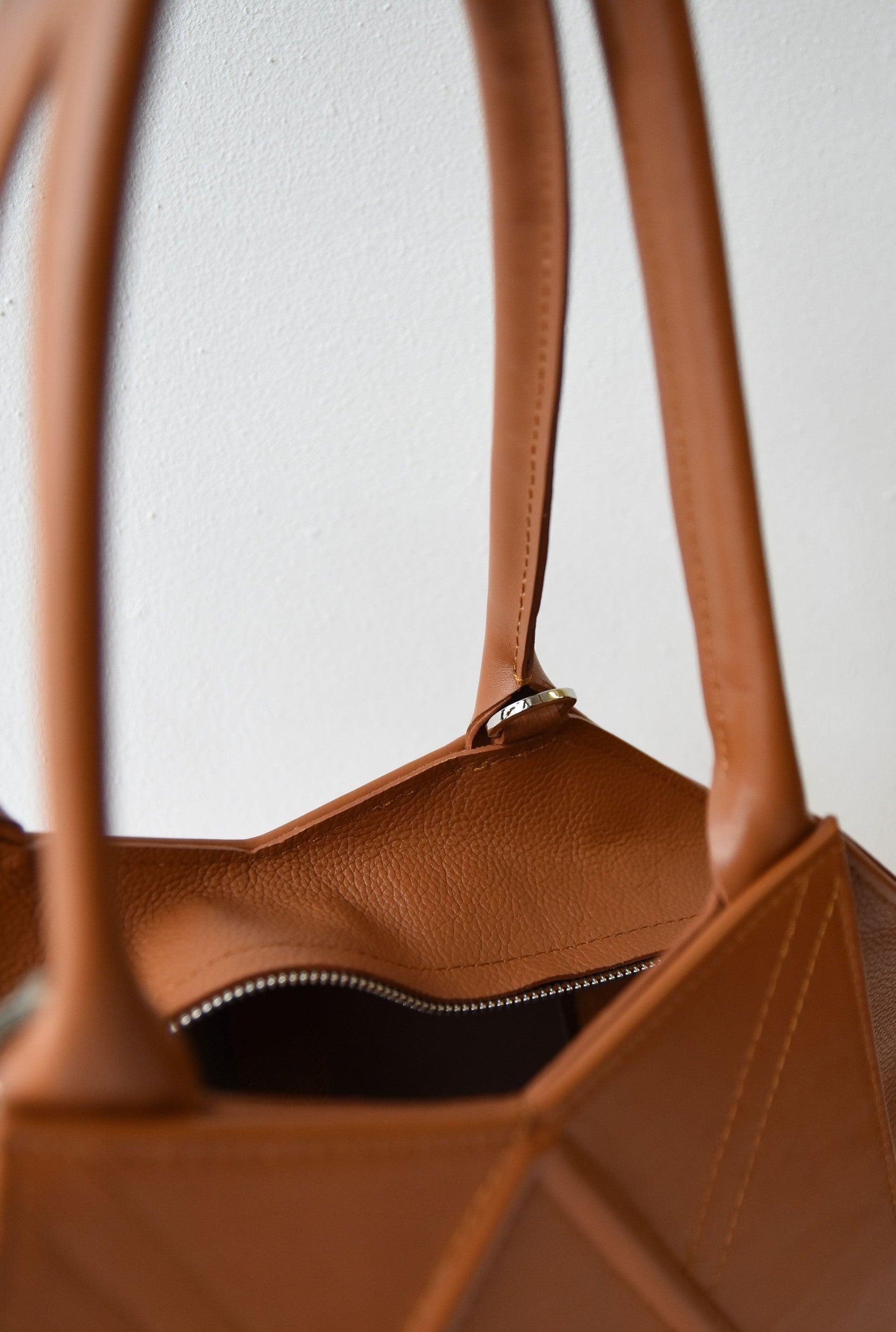 close-up of the gerda retter tote bag's magnetic closure and inner pocket