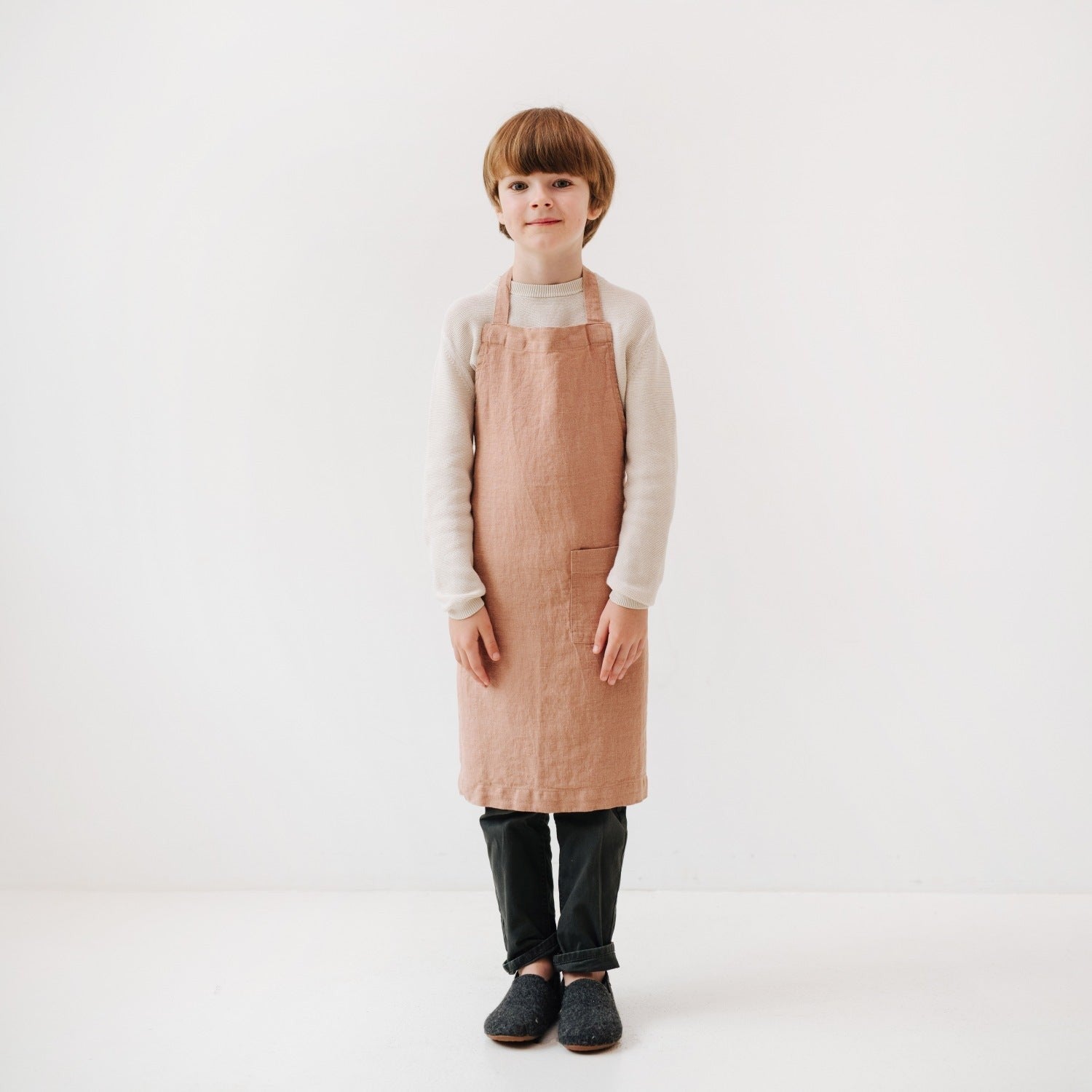 confident little chef in cafe creme linen apron with front pocket, ready for kitchen adventures
