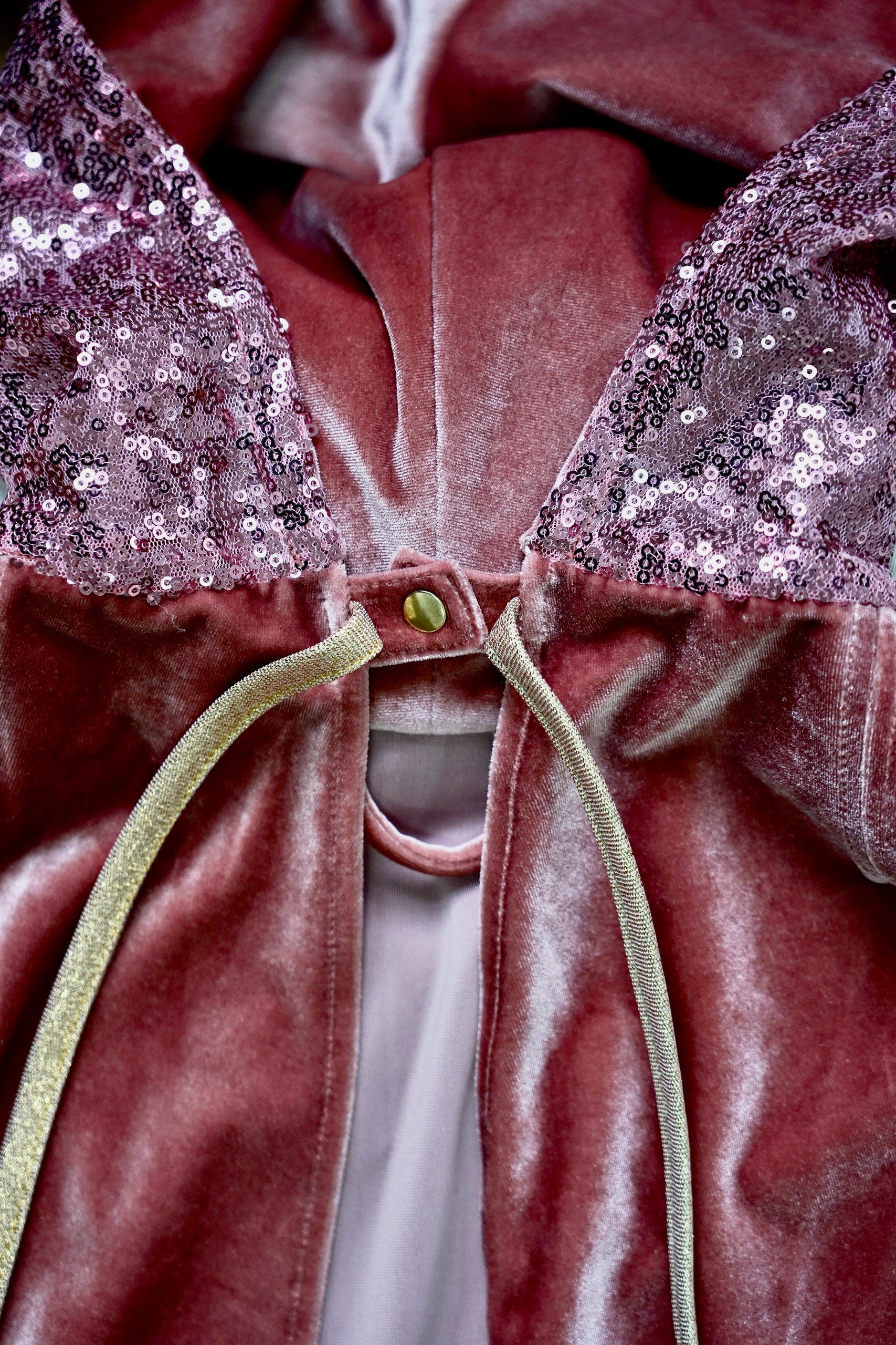 pink velour magic cape with a deep hood and snap fastening, perfect for fairy tale adventures and imaginative play