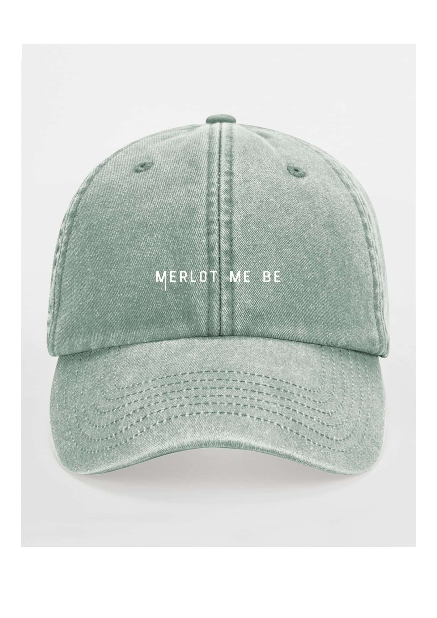 a playful merlot me be cotton cap tilted playfully on a sunny vineyard table