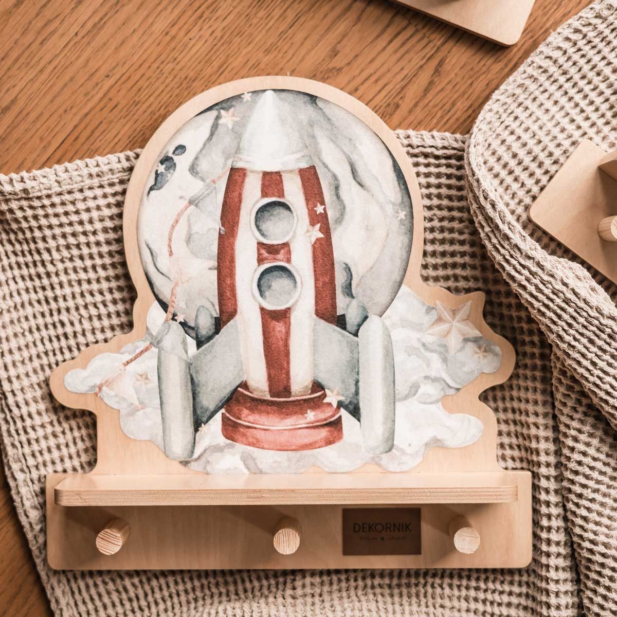 a playful rocketship wall shelf with a colorful dinosaur, seen from a fun low angle as if ready for takeoff