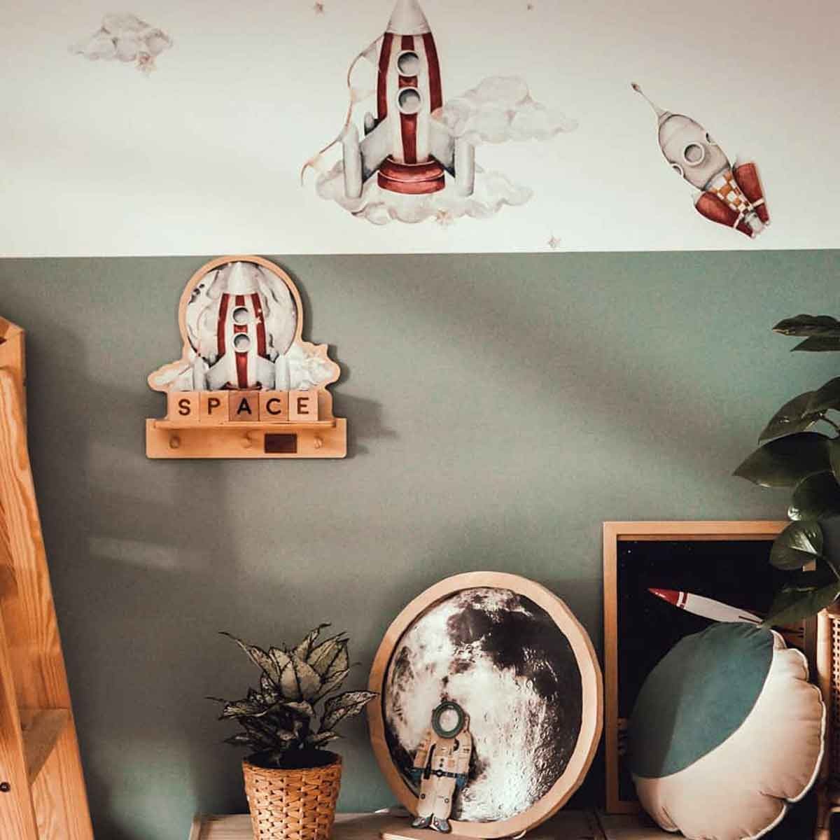 functional rocketship mini wall shelf mounted above a desk holding books and keys