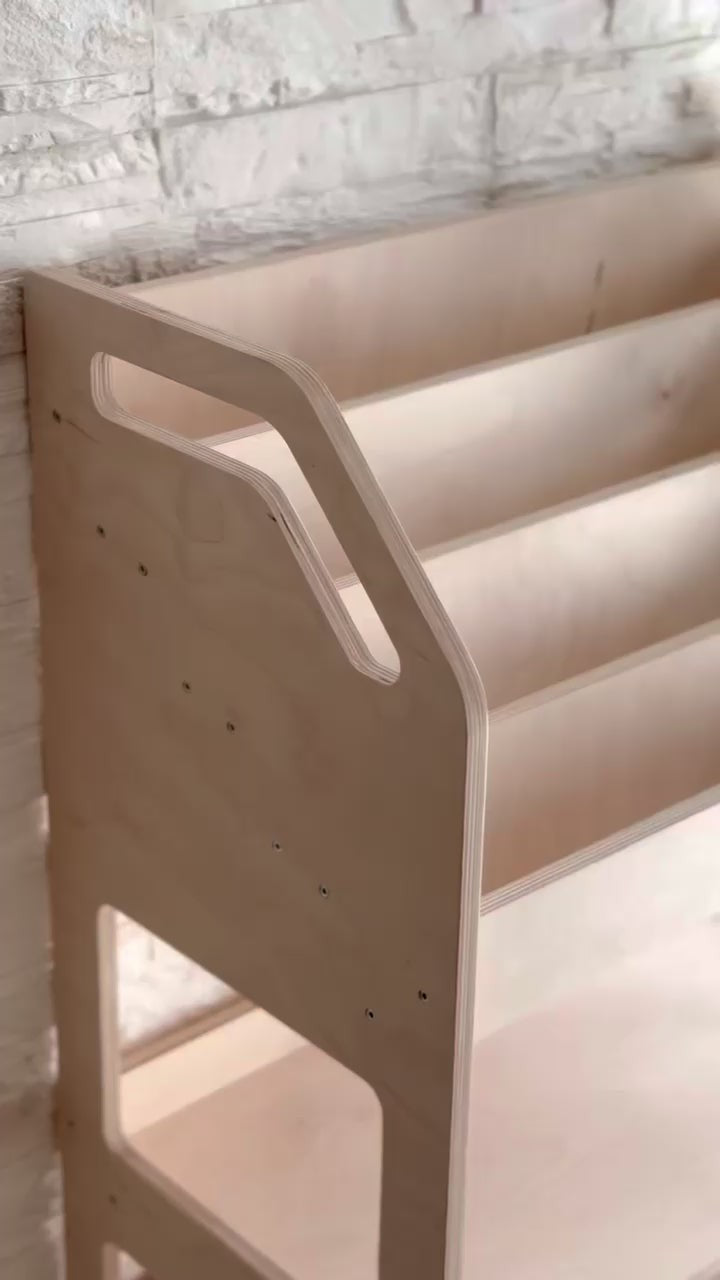 montessori bookshelf in a bright playroom showing accessible book display and deep toy storage