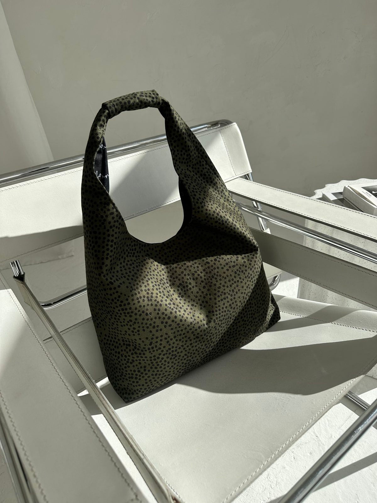 soft khaki polka dot moon bag heart held gently in warm morning light