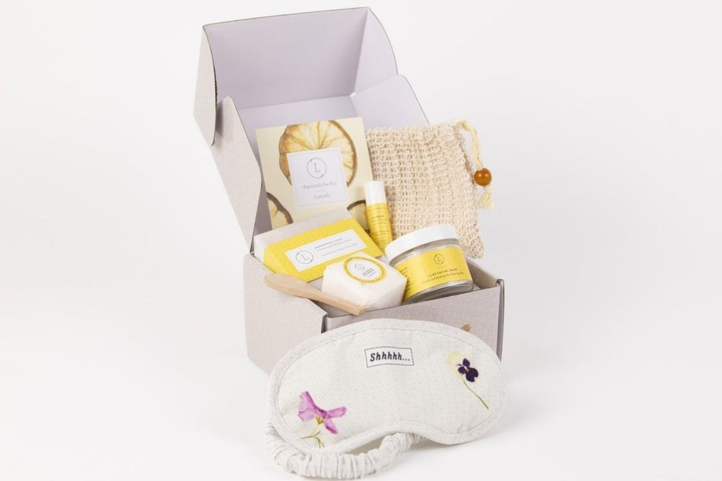functional arrangement of natural citrus skincare set on a wooden bath tray