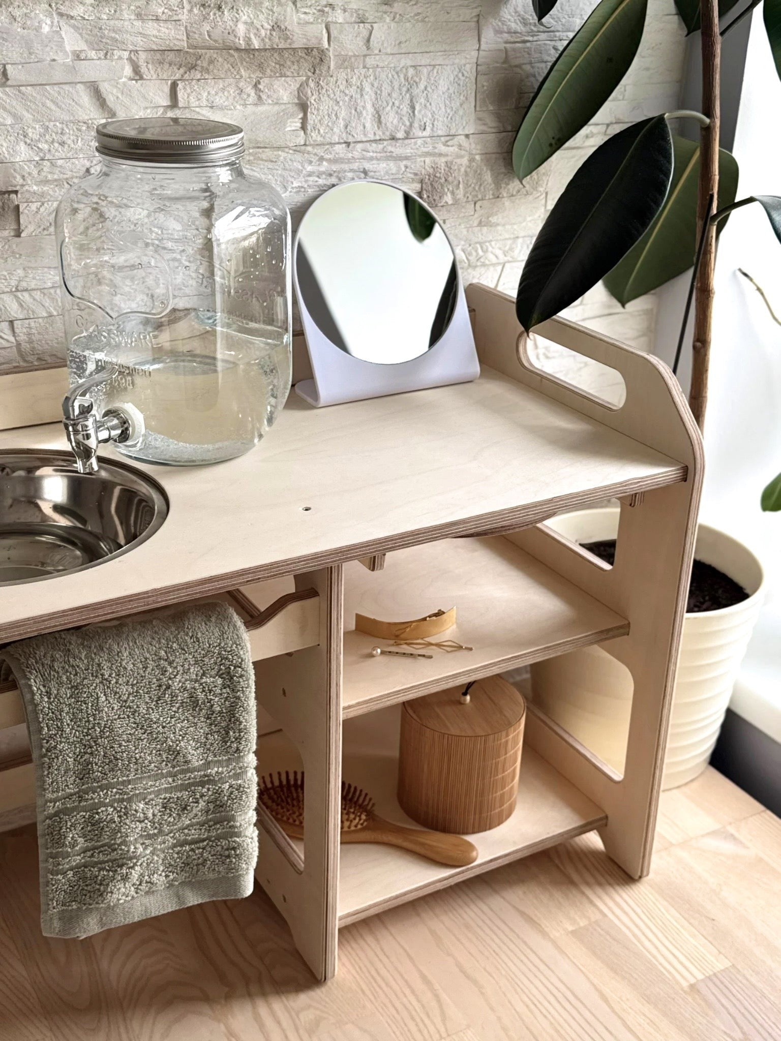 montessori wooden washbasin for toddlers in a bright, minimalist room with morning light